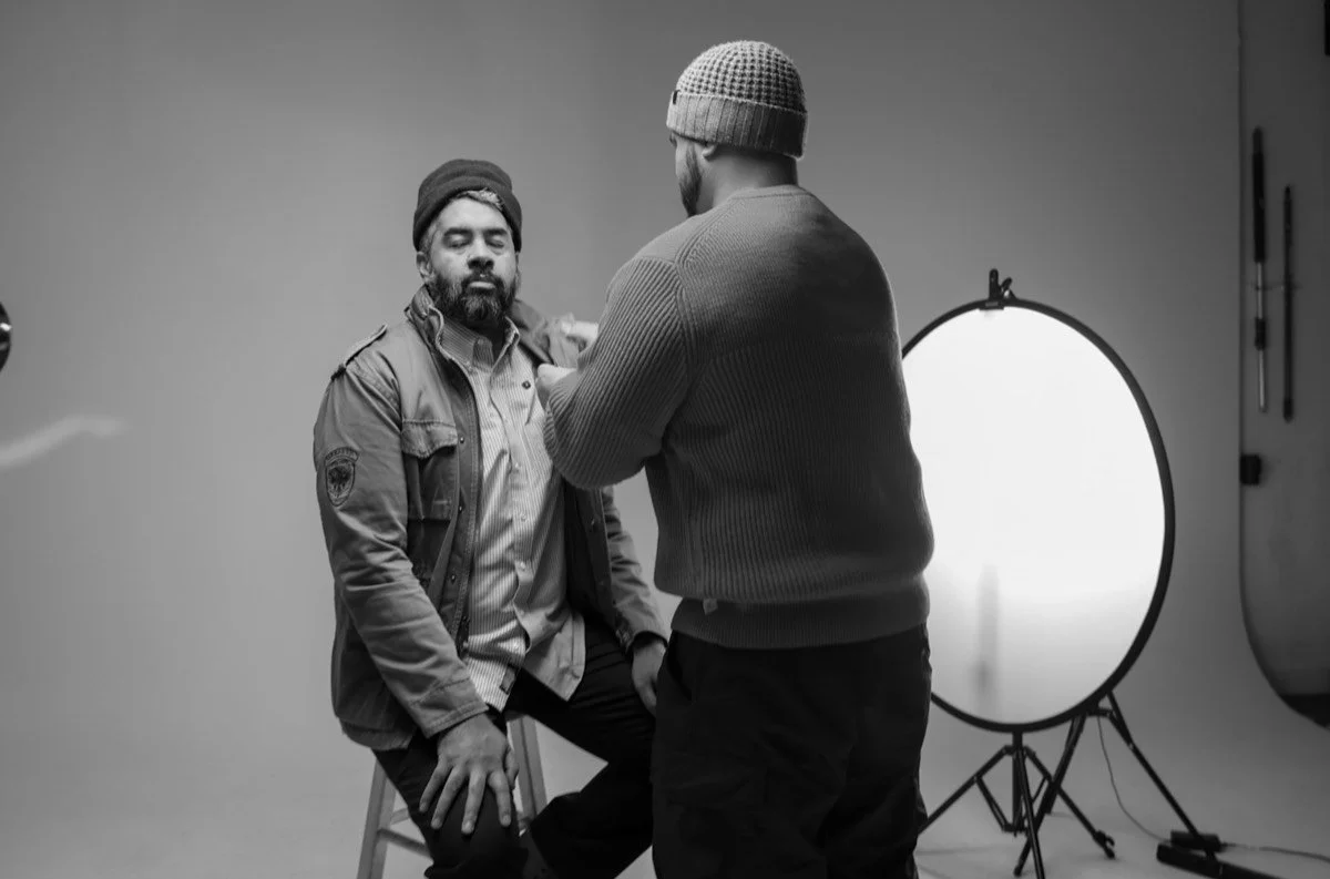 KLTRD MEDIA crew member adjusting an interview subject's lavalier mic before a studio interview