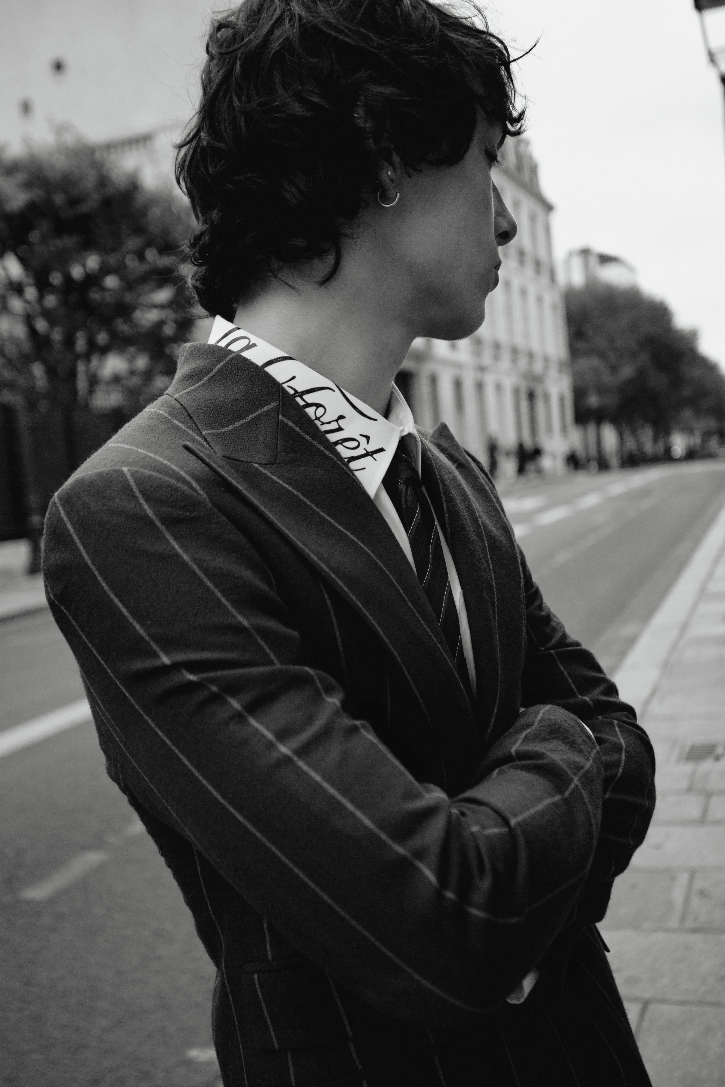 Portrait of Paris Rebel wearing Selection Marais suit, photographed by Ori Paul Levi
