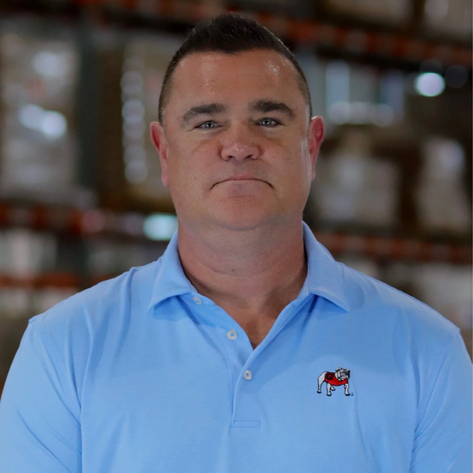 A man in a blue polo.