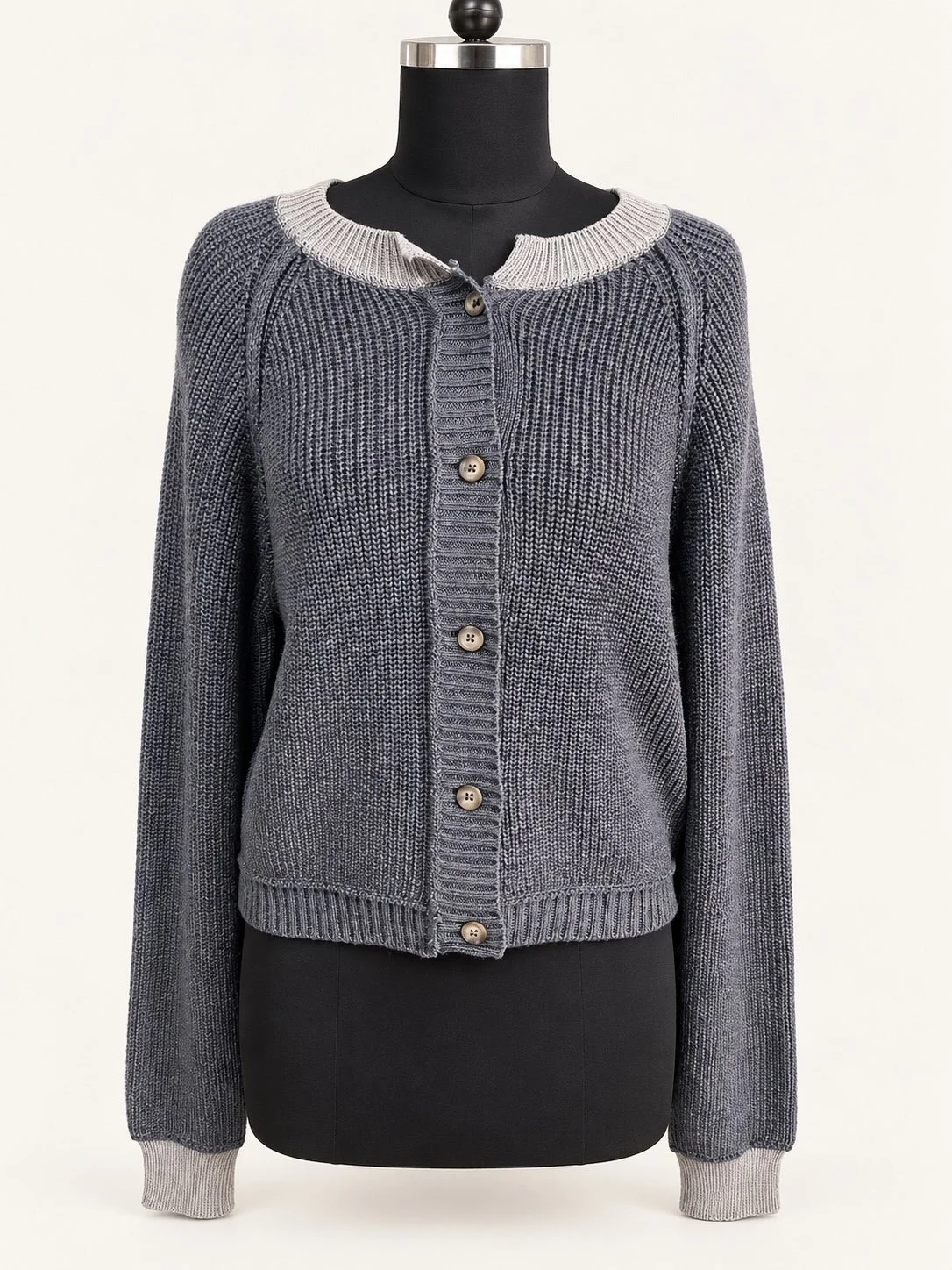 Slate-grey textured knit cardigan with button front, displayed on a dress form from our product development archive.