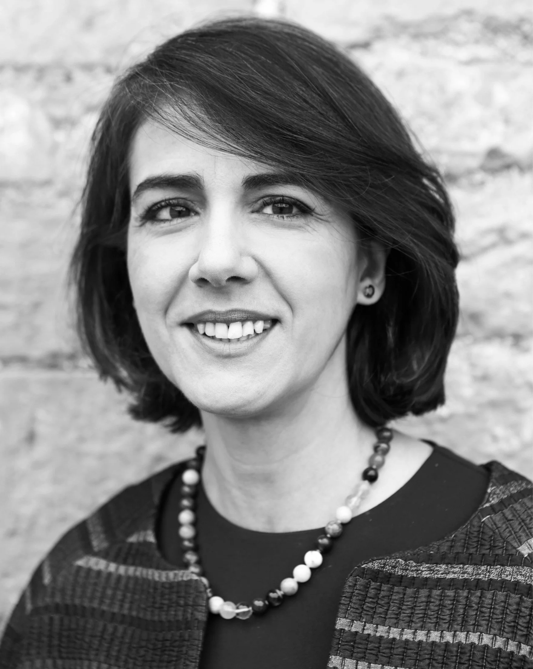 Çiğdem Baker, co-founder and UK director of Pure Design Fashion, in a black-and-white portrait.