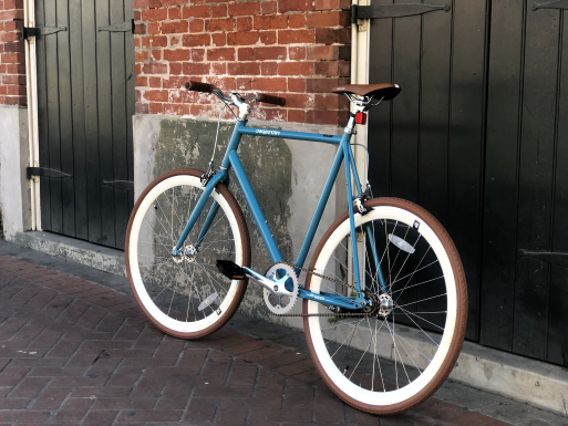 auqa color road bike on a french quarter sidewalk