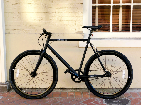 black road bike on the sidewalk in the new orleans french quarter