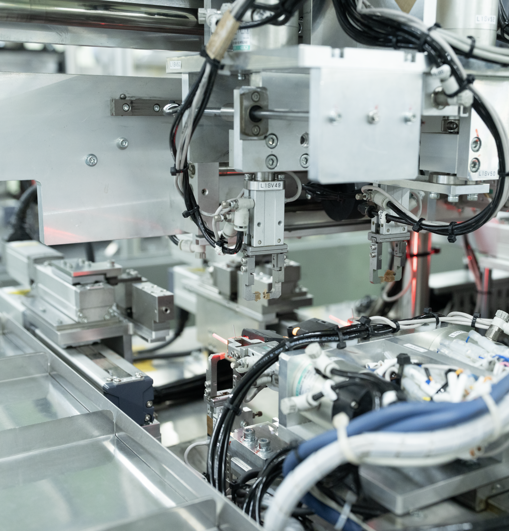 Close-up of laser cutting machinery in a factory setting.