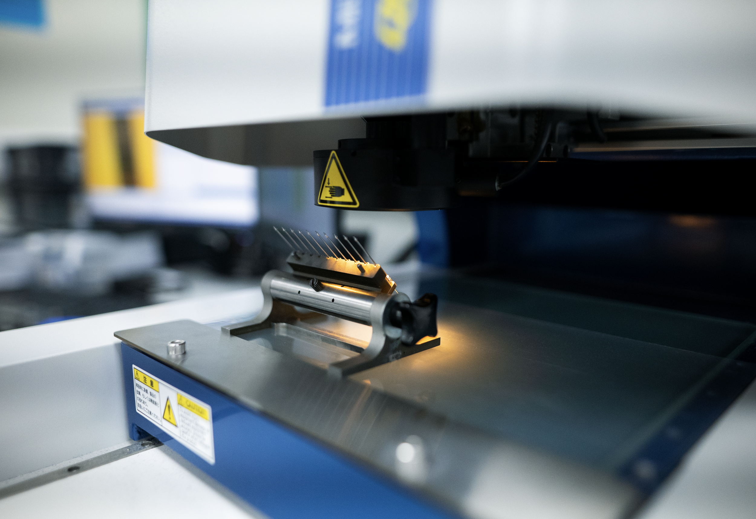 Precision manufacturing equipment processing thin metal components for medical device applications.