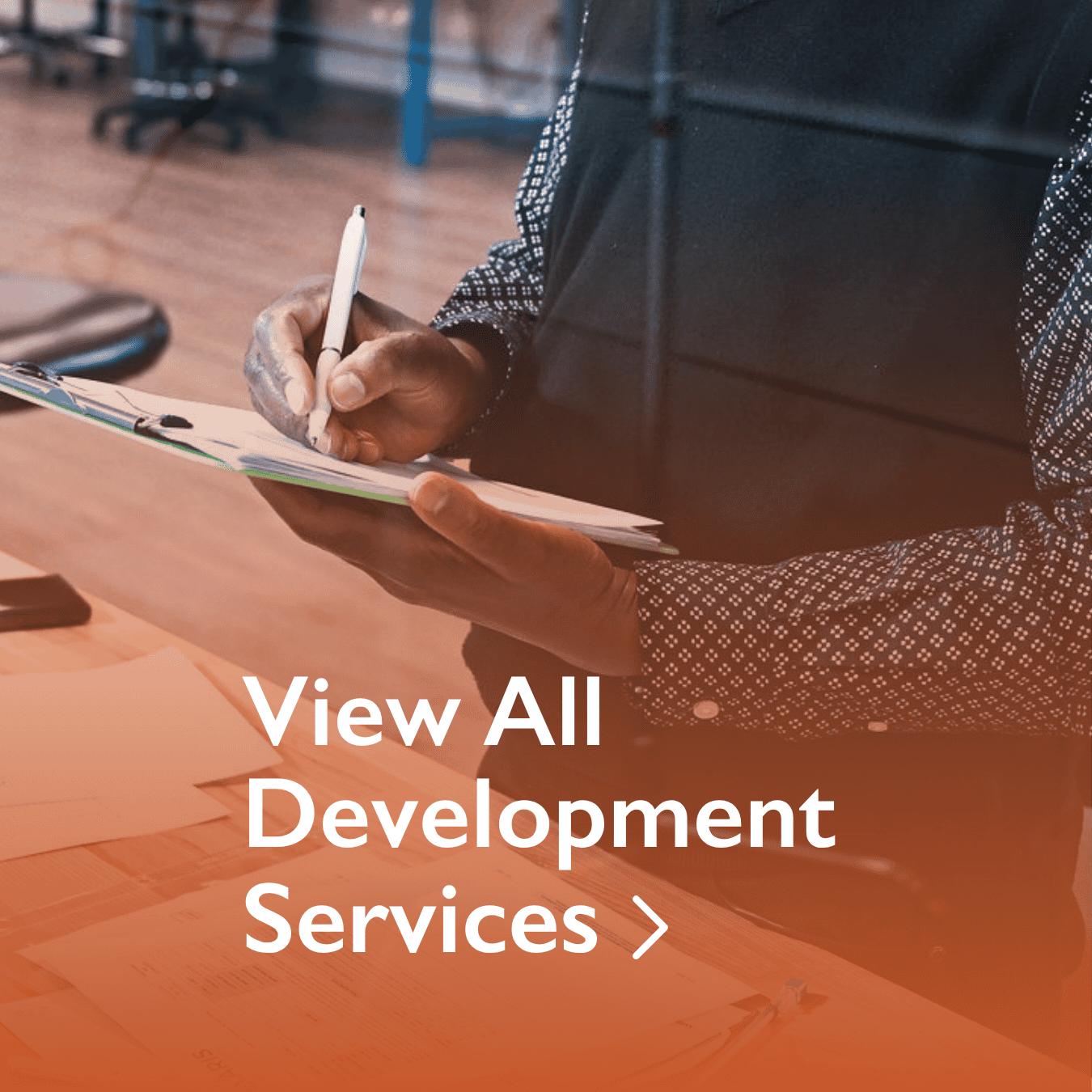 Specialist documenting design inputs in a medical office with overlay text: "View All Development Services"