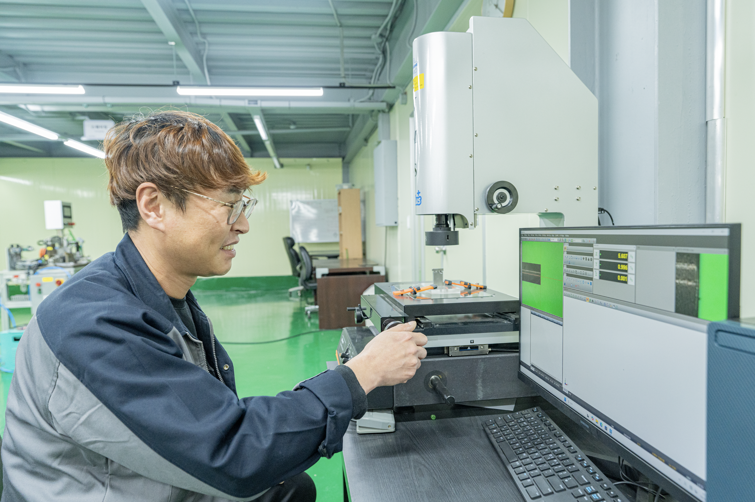 Technician operating precision equipment used in medical device manufacturing and component production.
