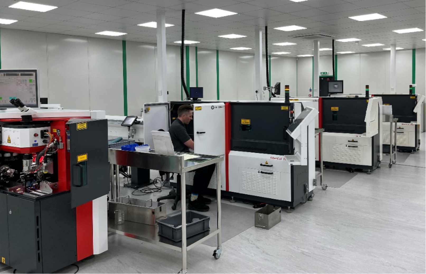 Technician working with advanced equipment for precision medical device component manufacturing.