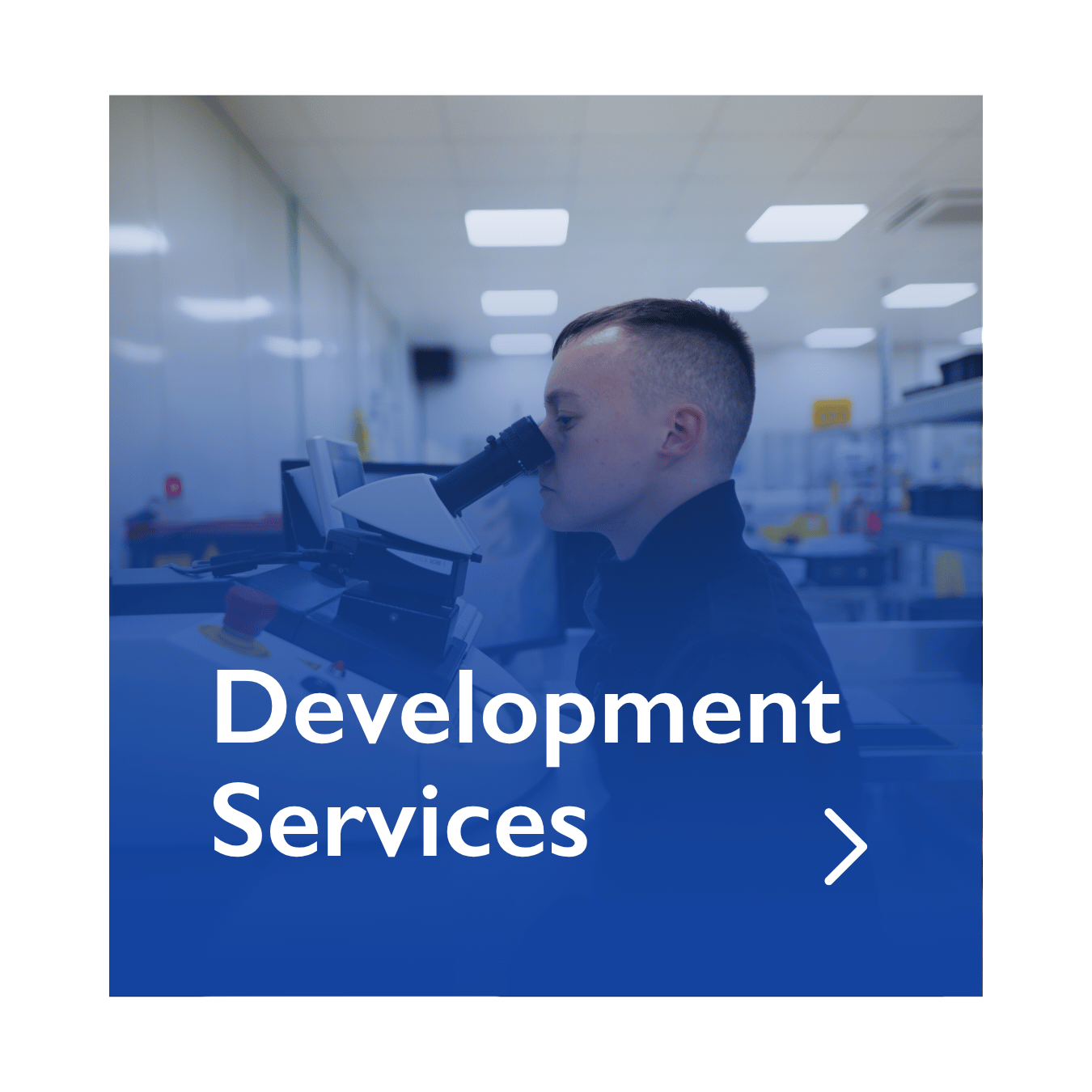 Person working for Elevaris looking into a microscope in a laboratory setting.