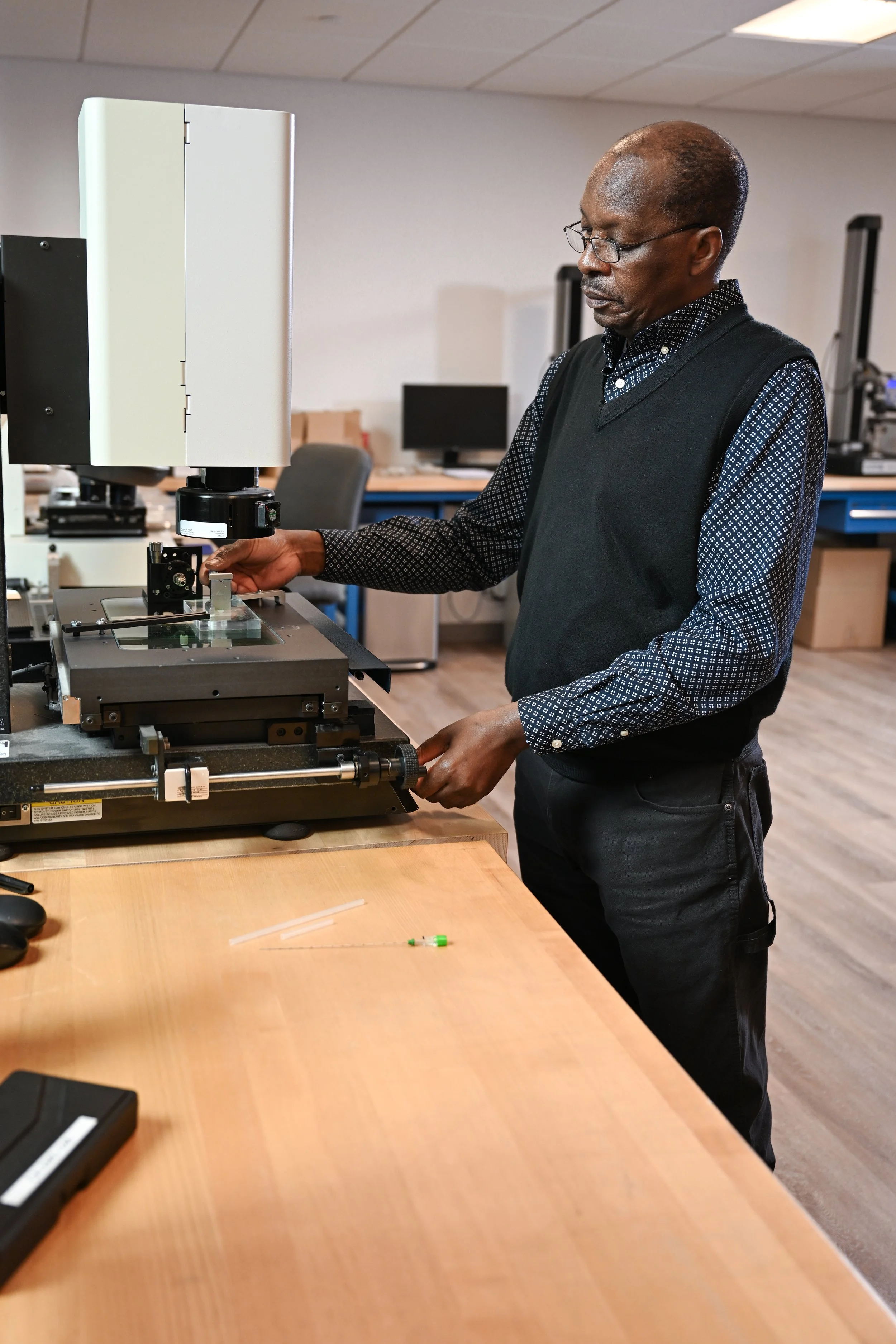 Elevaris technician working with equipment used in medical device development and manufacturing.