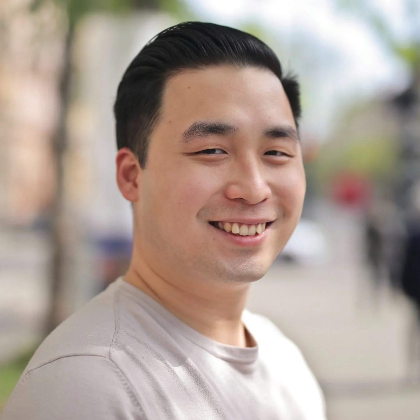 Asian man standing in an urban setting, looking ahead with quiet strength—representing healing from past trauma and reclaiming safety