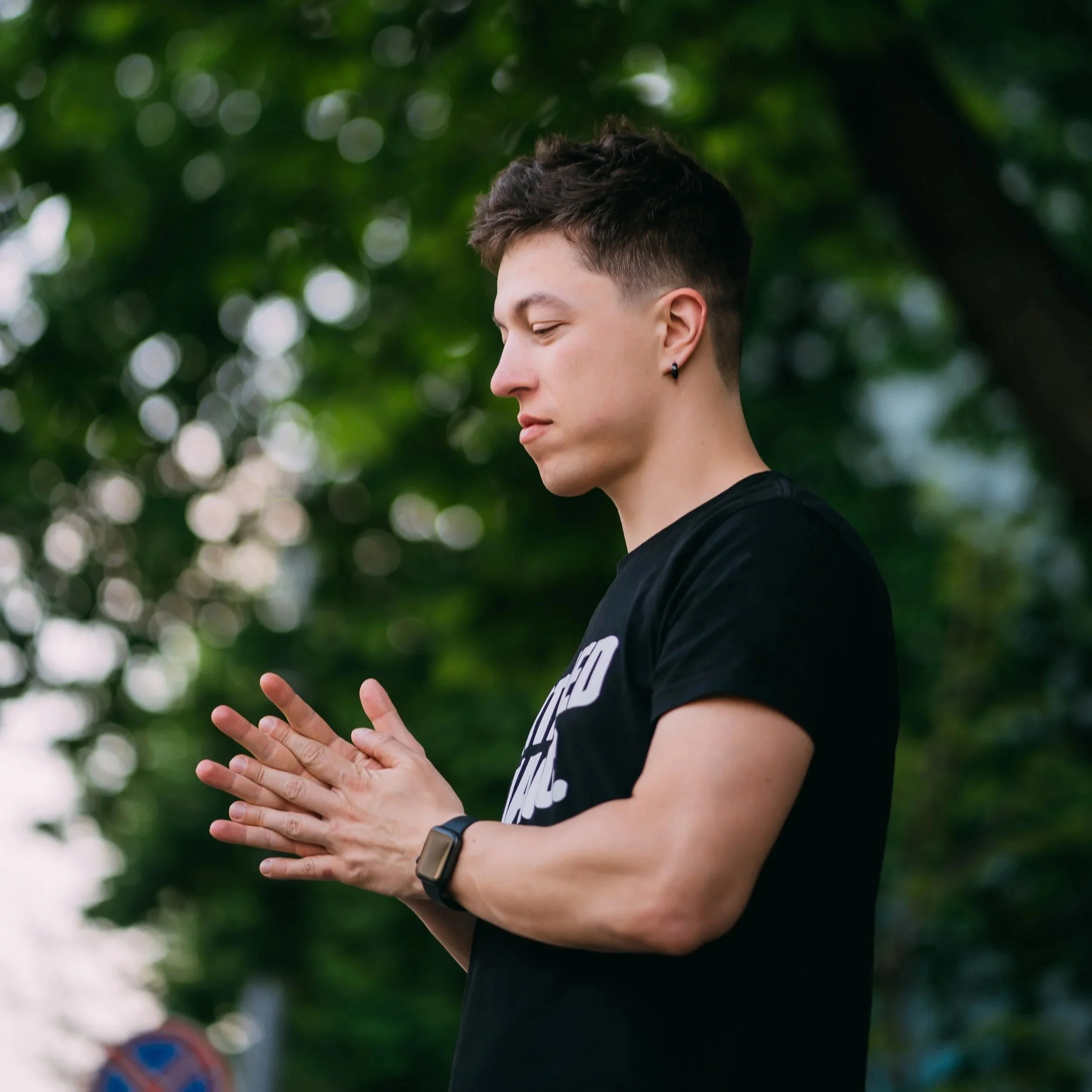 Young man standing on a sunny city street looking relaxed and grounded after completing Guidance Teletherapy’s Empowered Relief program