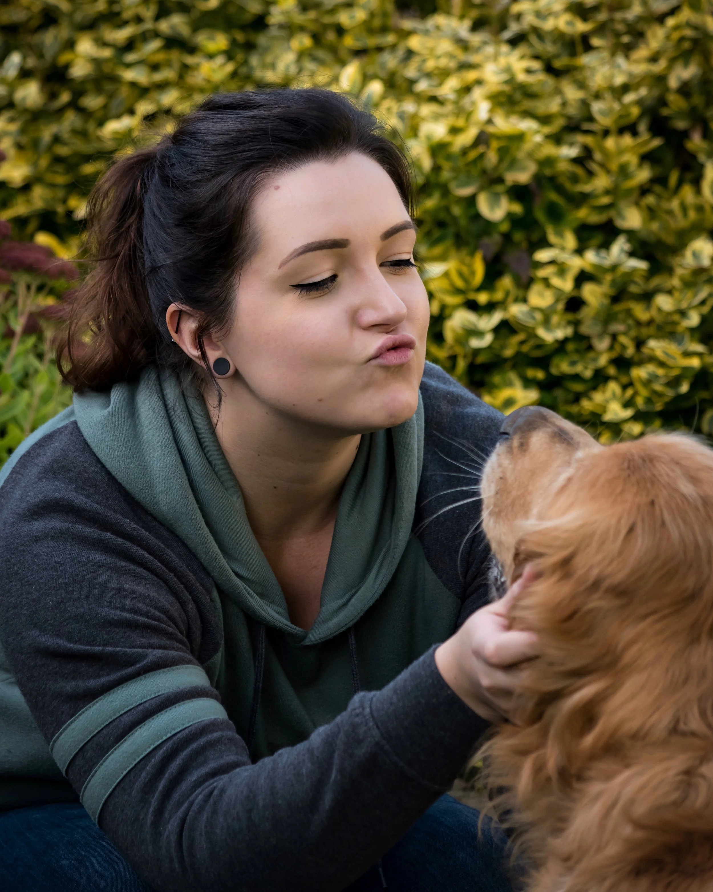 Image of a woman smiling with her dog, representing Guidance Teletherapy’s ESA assessments and emotional support animal letter services