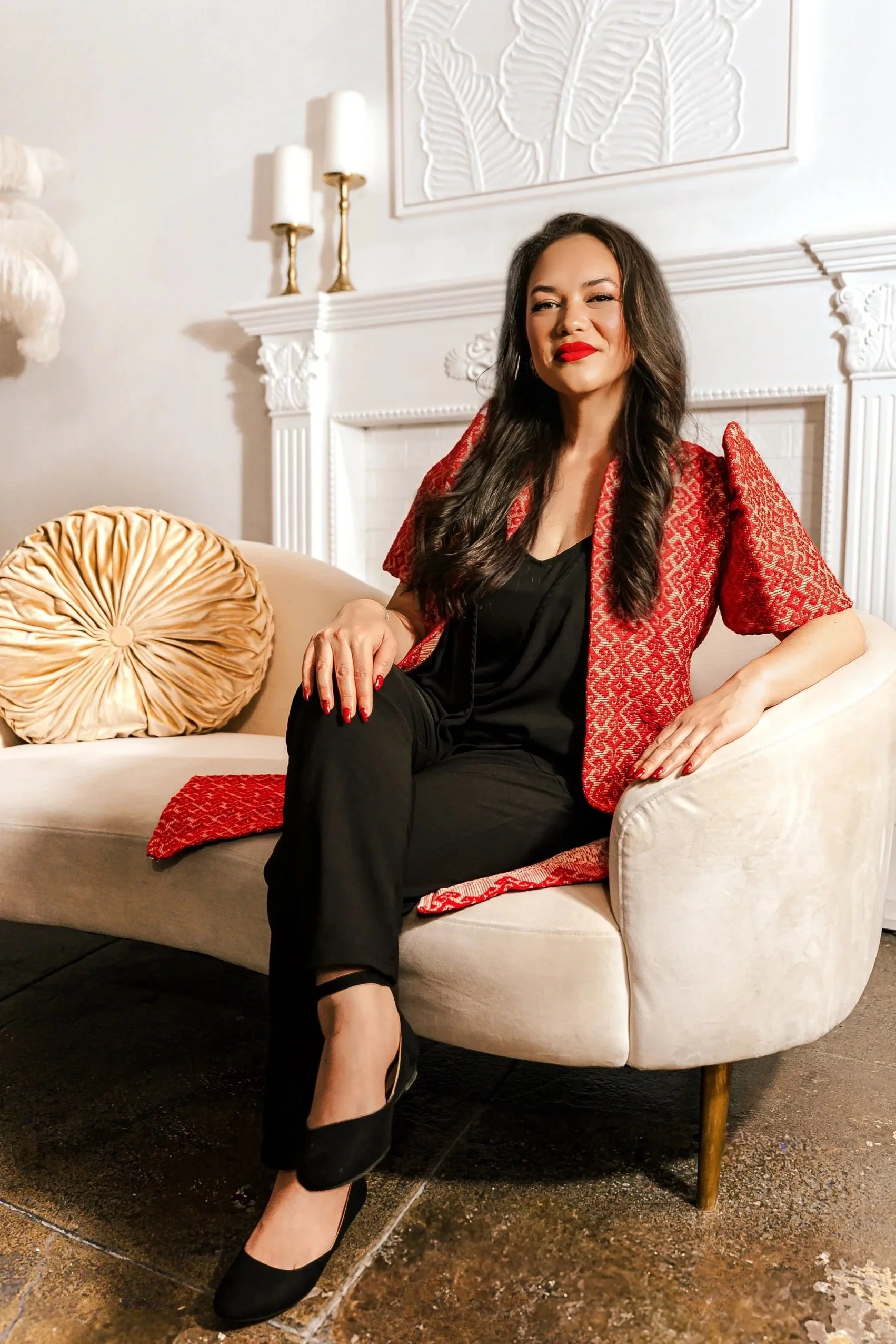 Therapist Ariel Landrum, founder of Guidance Teletherapy, seated on a couch and smiling warmly—professional portrait representing compassionate virtual care