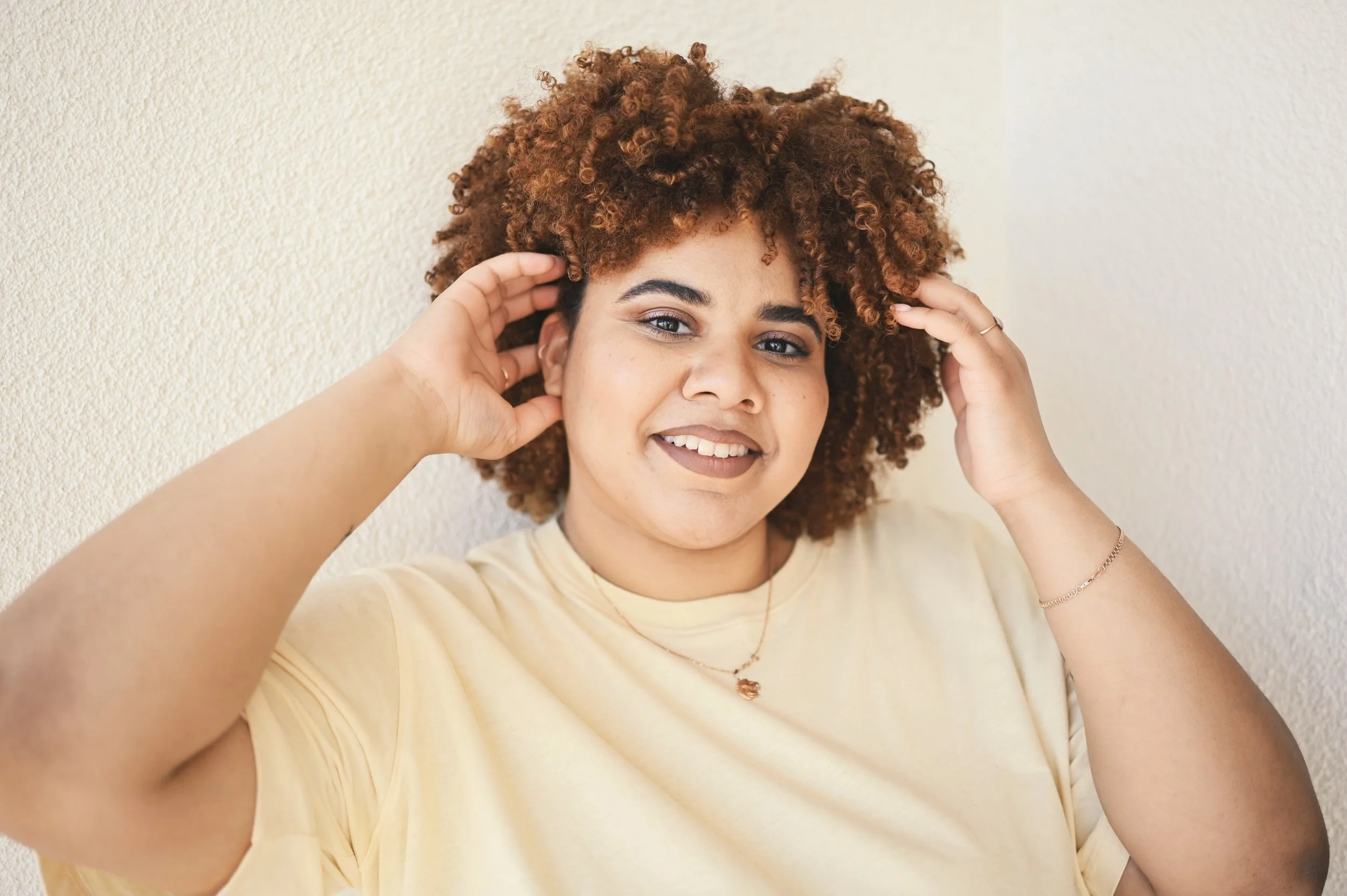 Confident Black woman smiling warmly—embodying self-worth, post-traumatic growth, and emotional restoration
