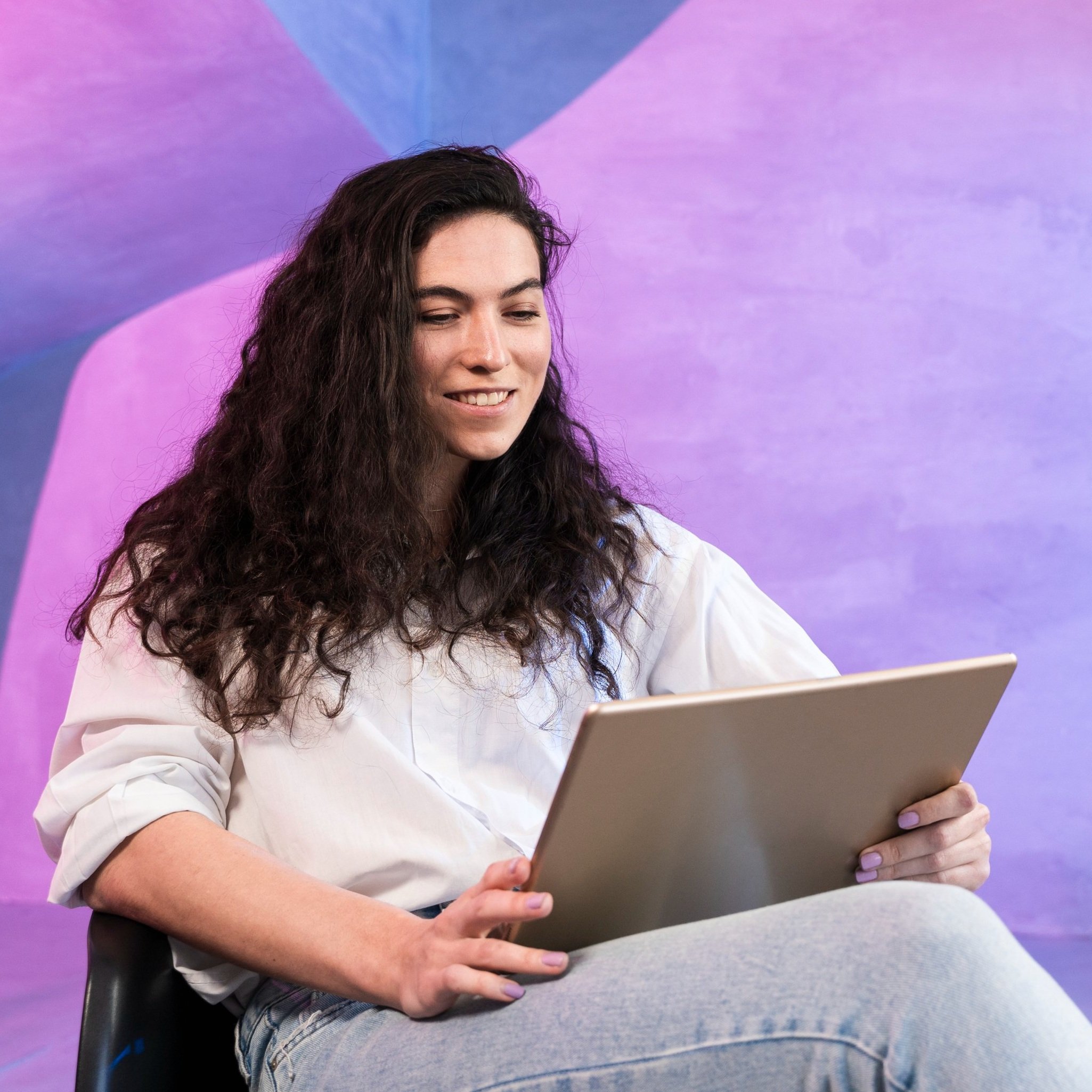 Image of a woman using a laptop in a home office setting, representing accessible online therapy with Guidance Teletherapy