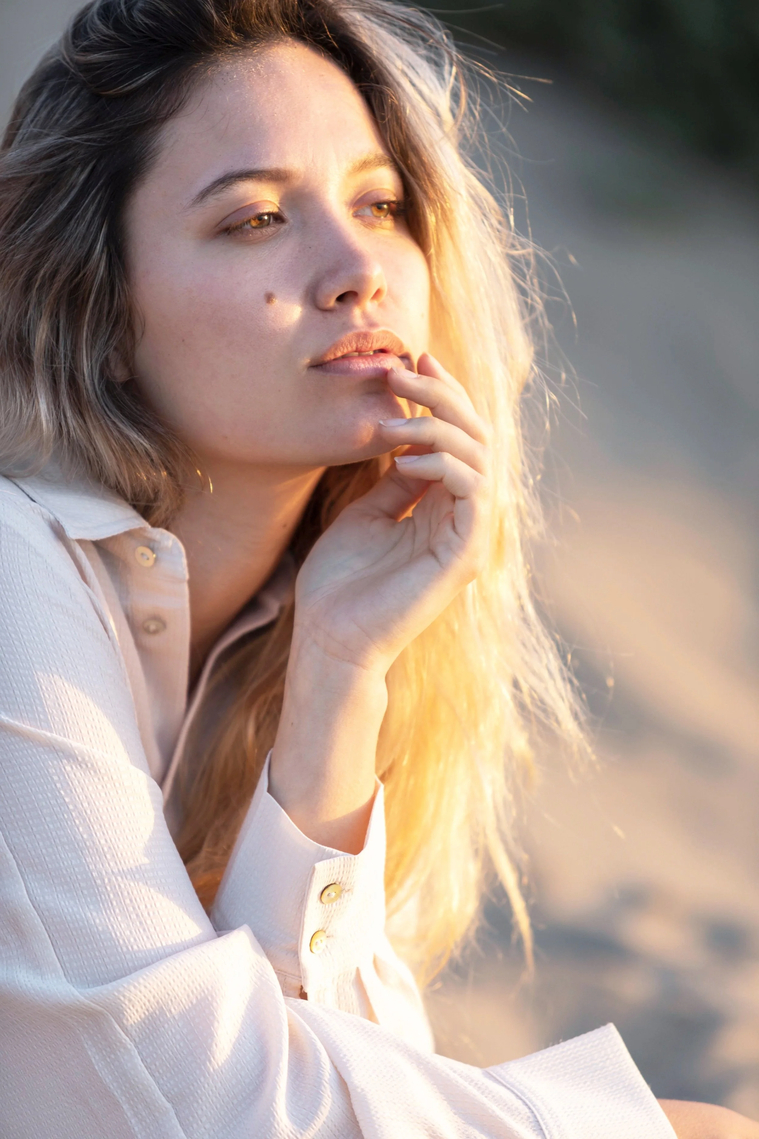 Portrait of a woman outdoors, in calm reflection—symbolizing grounding, resilience, and the journey through trauma therapy