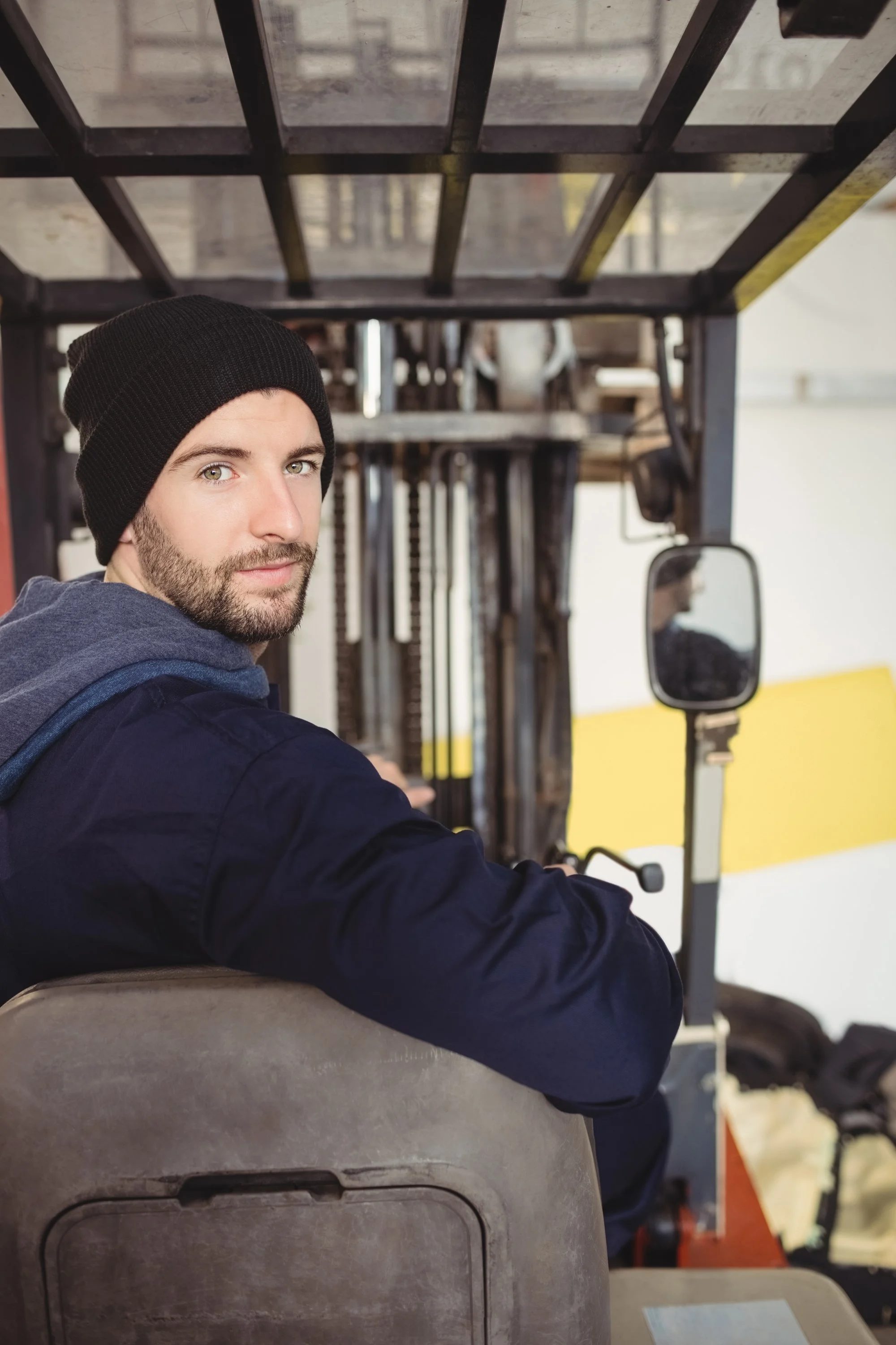 Mechanic sitting on a forklift in a workshop representing professionalism accountability and the return-to-duty process supported through Guidance Teletherapy’s DOT SAP assessments