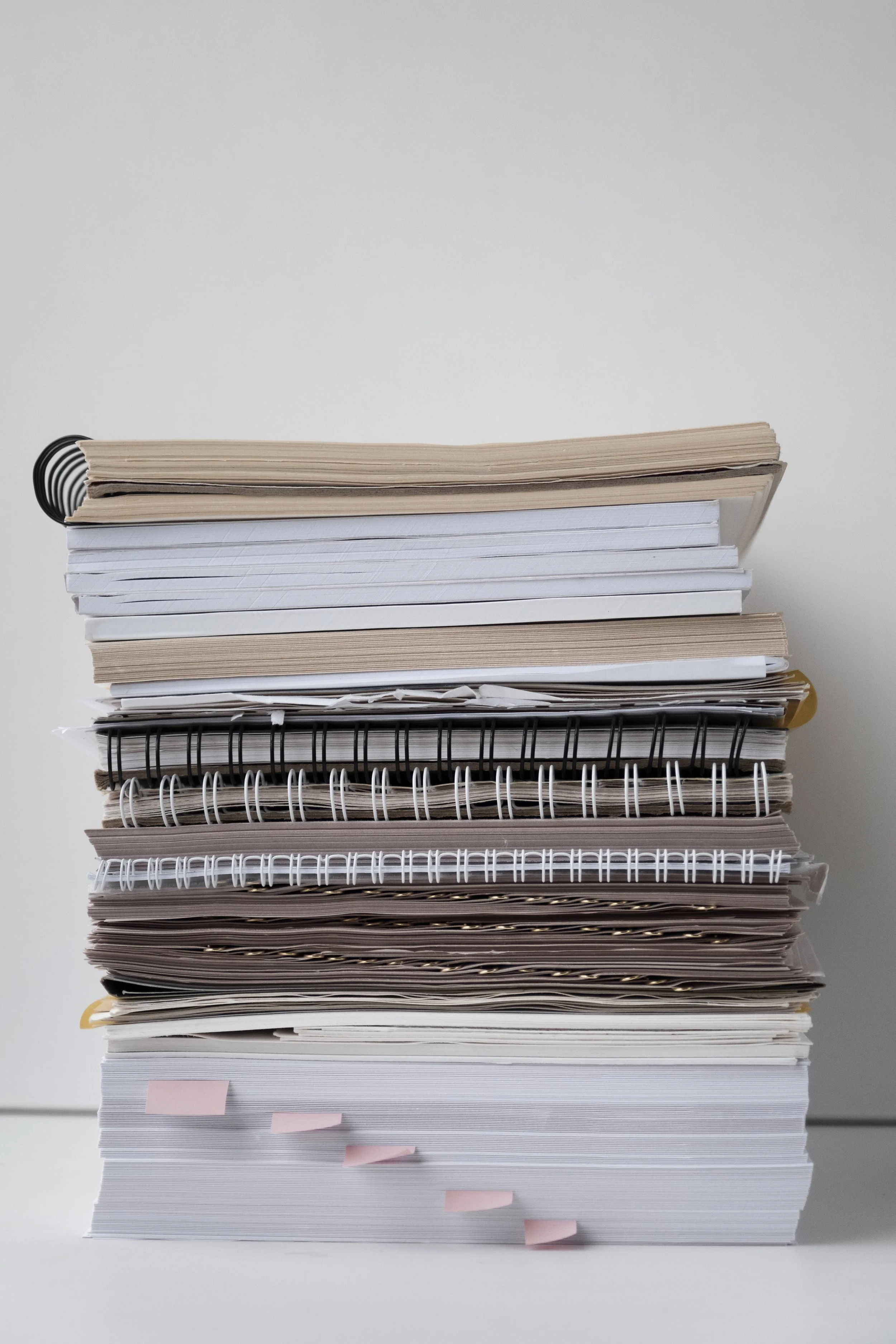 Image of organized paper stacks and documents, representing accessible tools, worksheets, and support materials available through Guidance Teletherapy’s Client Resources