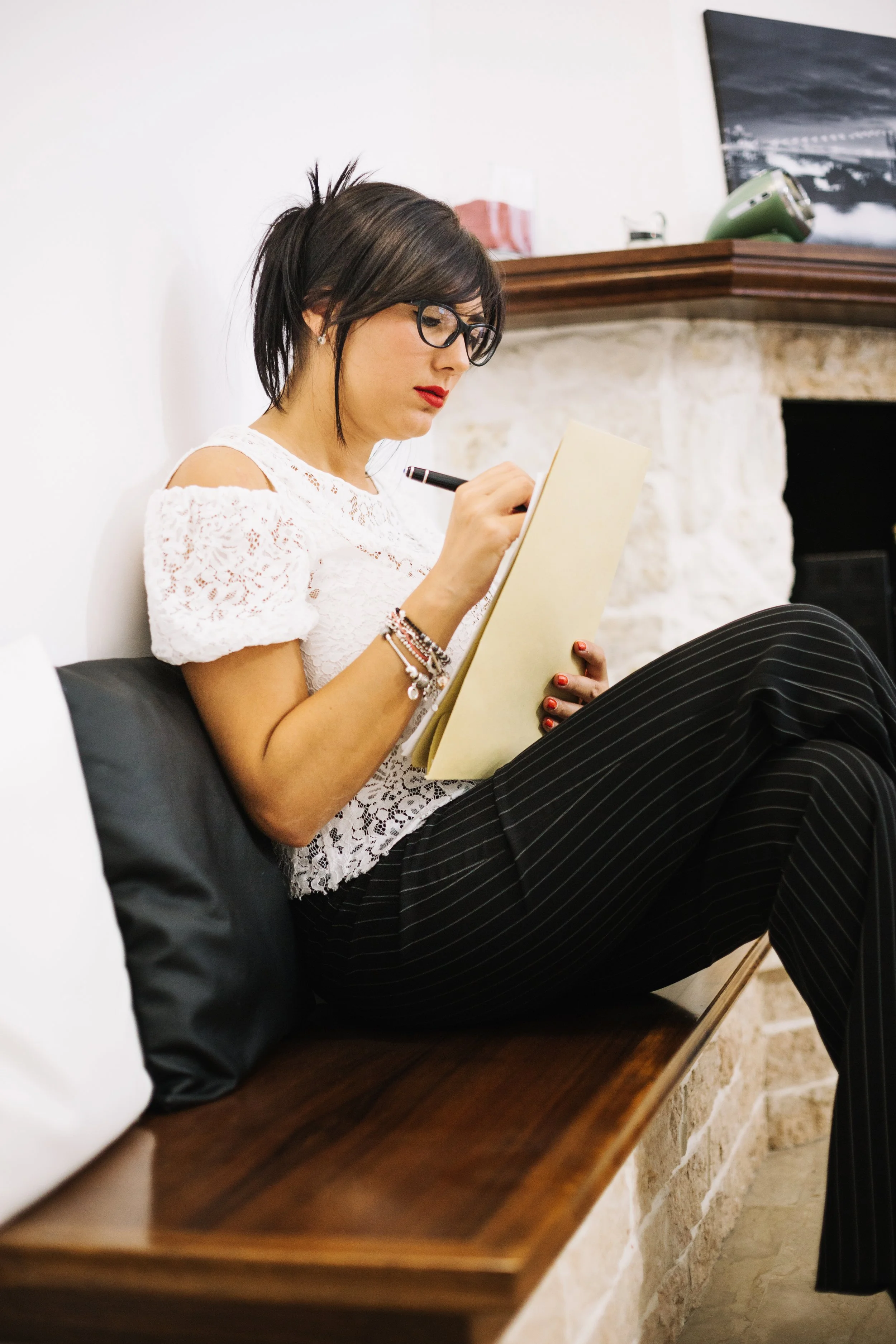 Woman reviewing creative documents at her desk representing Guidance Teletherapy’s entertainment industry consultation services that help writers and producers ensure accurate and ethical mental health portrayals in media