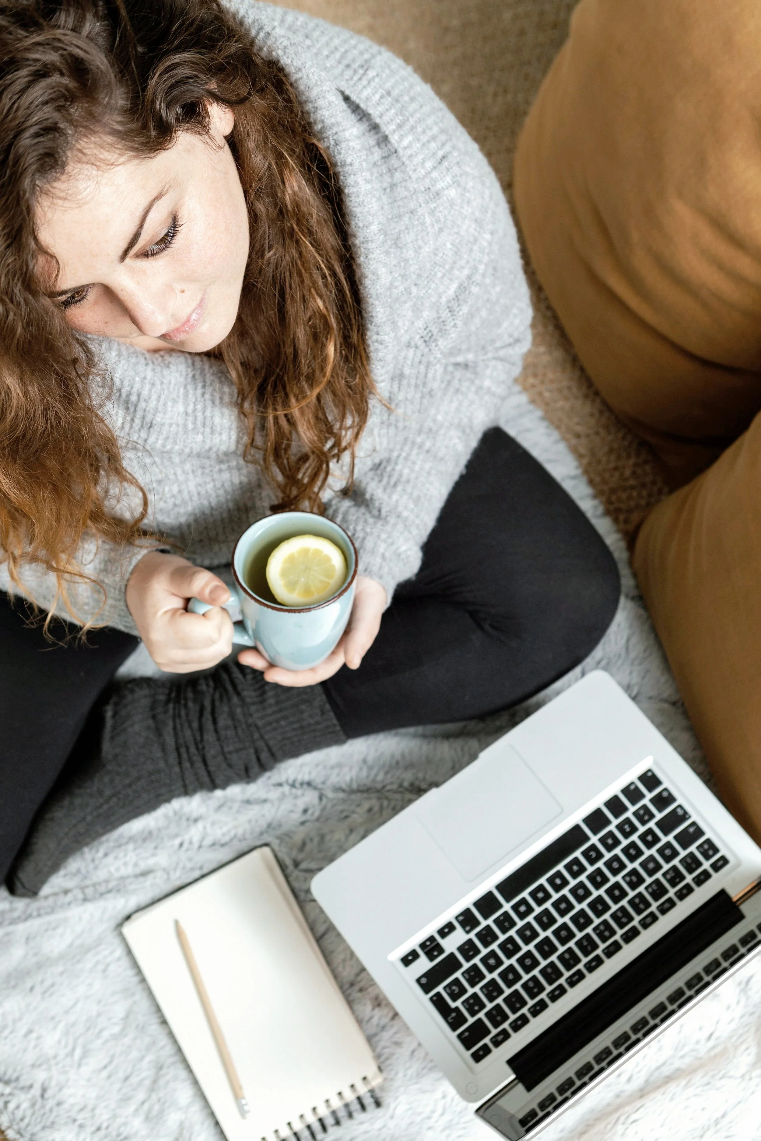 Image of a woman at home using a laptop—representing flexible, accessible online therapy sessions from the comfort and privacy of your own space