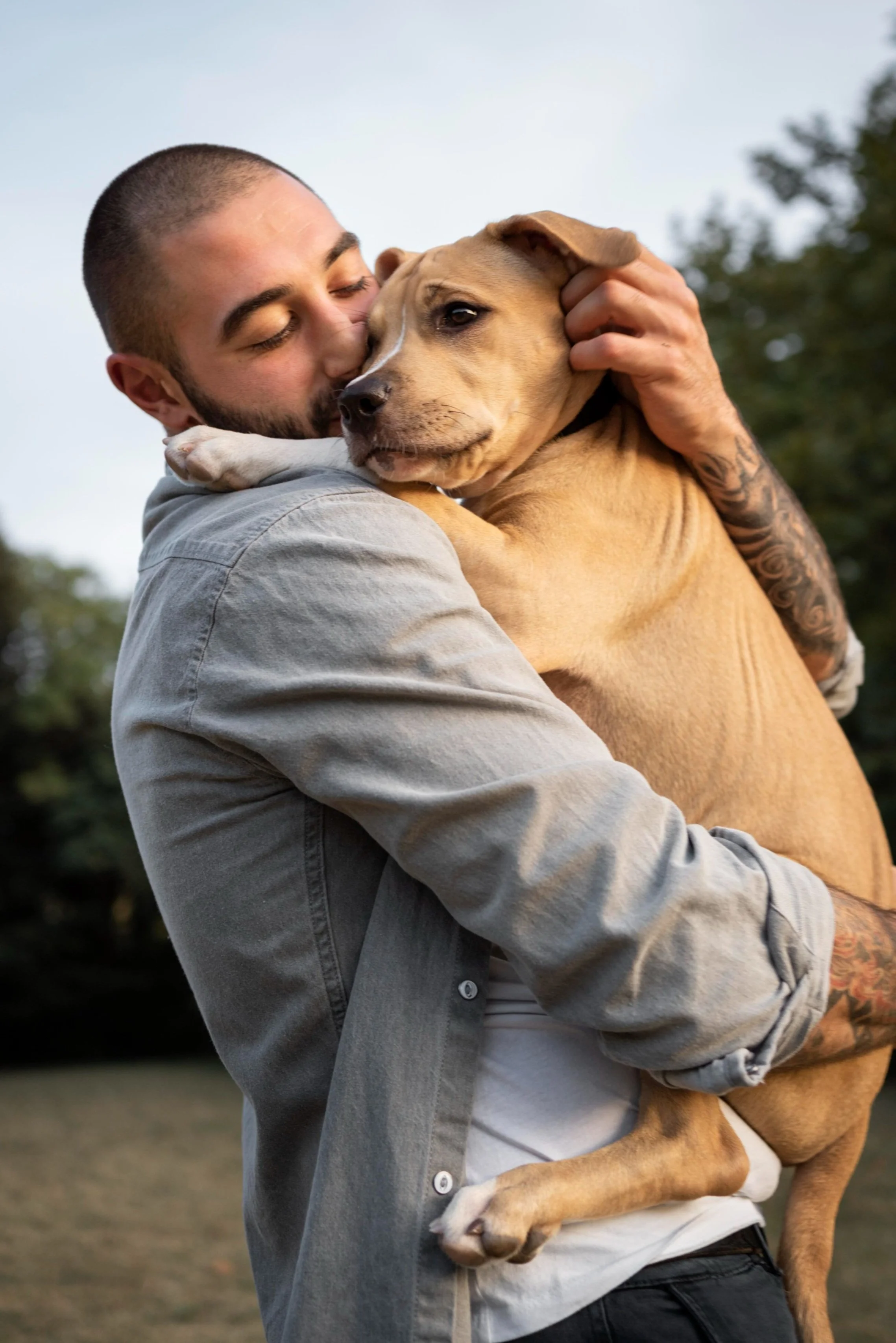Man hugging his dog and smiling showing connection trust and emotional comfort that reflects the supportive bond recognized through Guidance Teletherapy’s emotional support animal assessments