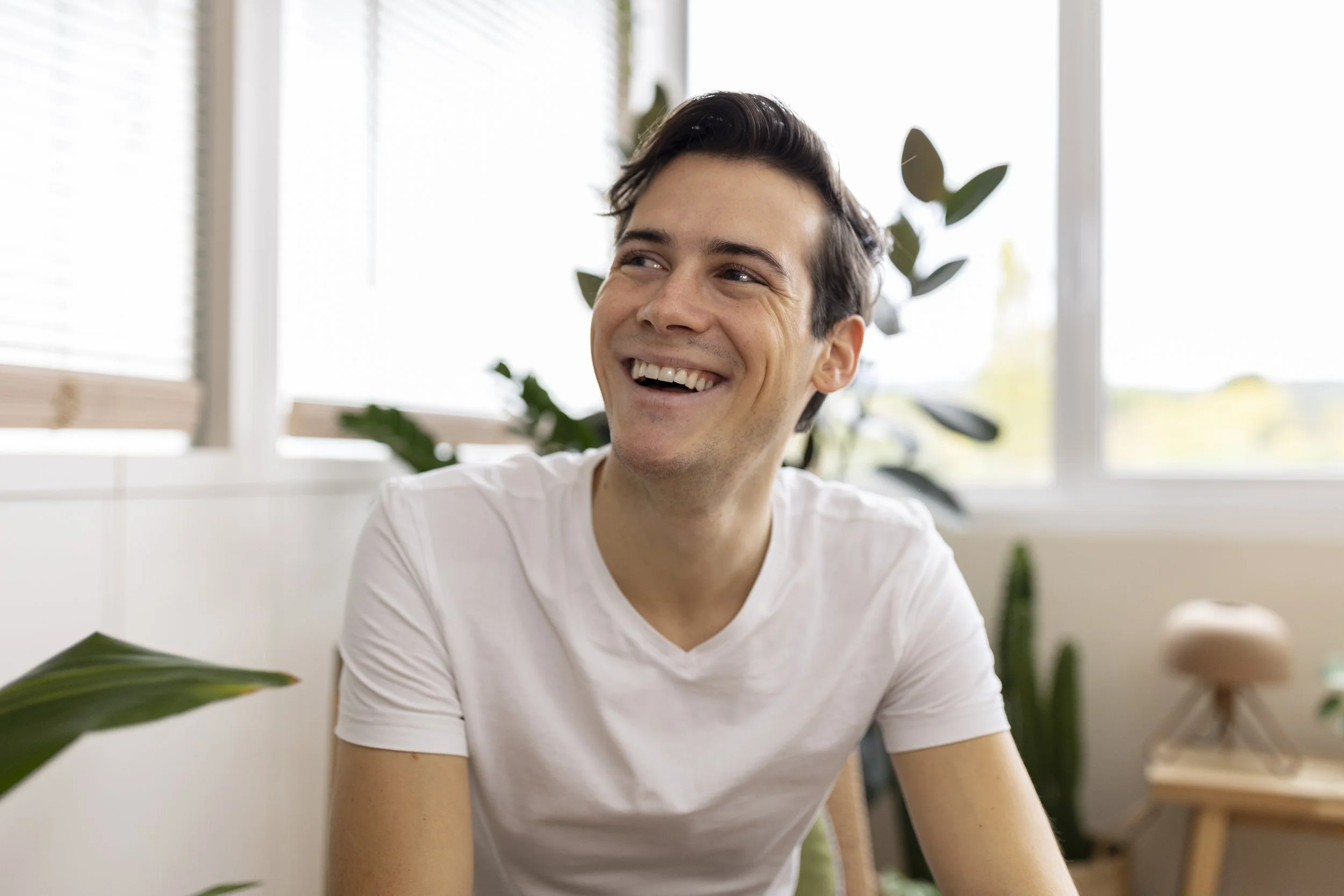 Image of a young man smiling confidently, symbolizing empowerment and approachable online therapy at Guidance Teletherapy