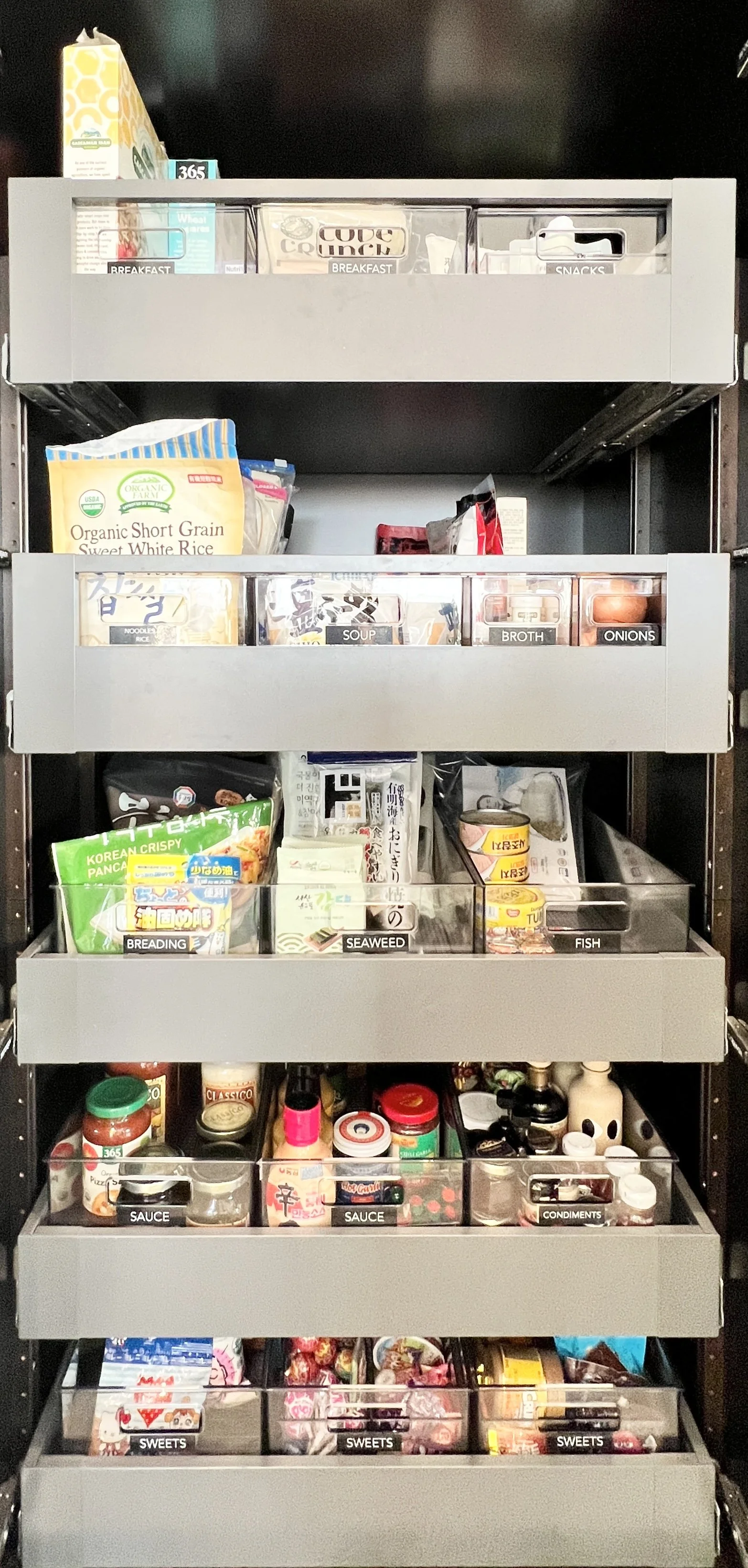 Feature full-height pantry organization in Palos Verdes Estates, California, showcasing labeled pull-out drawers for breakfast items, snacks, soups, sauces, condiments, and sweets. Intuitive zoning and clear storage solutions support efficient meal p