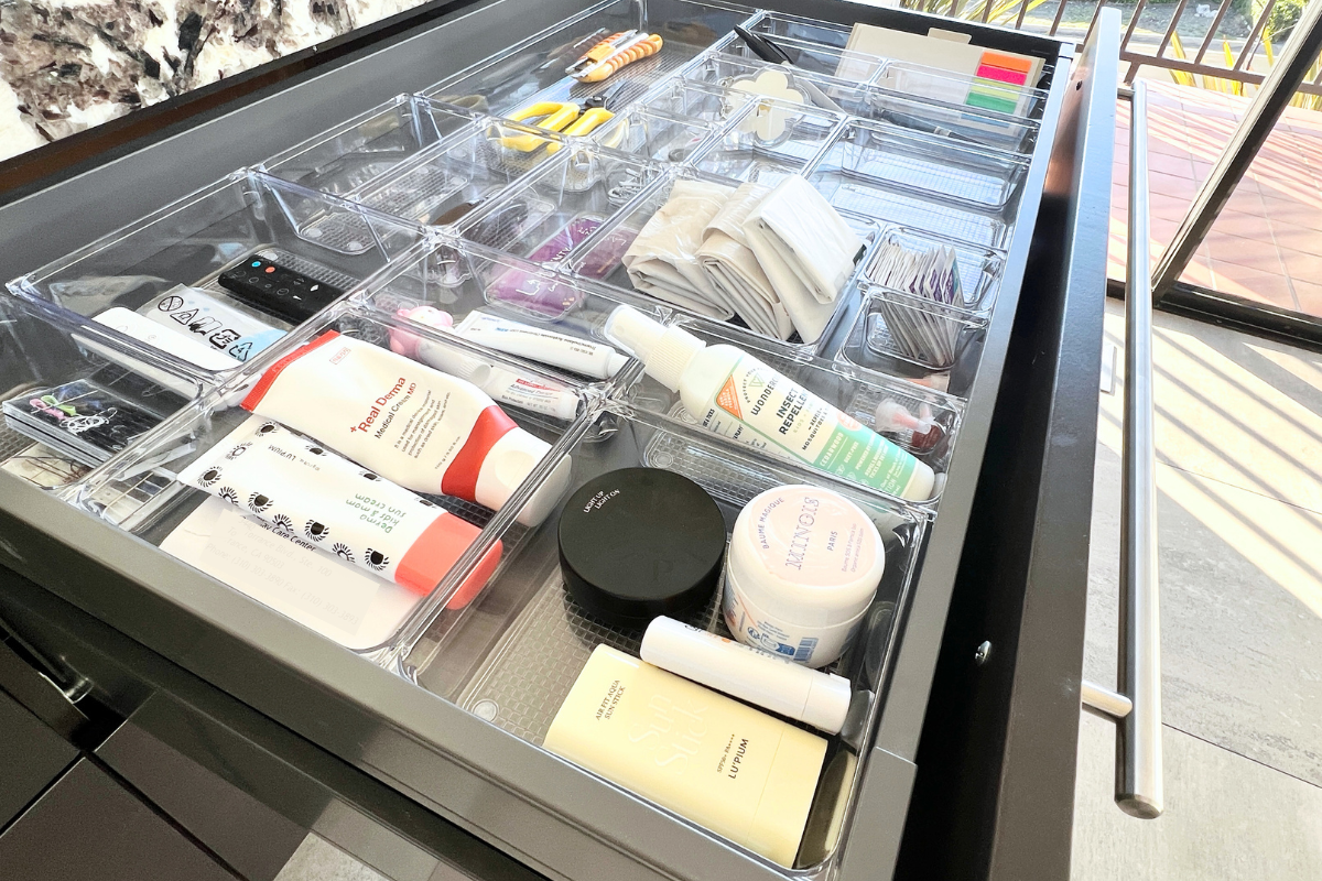 Organized kitchen drawer in a Palos Verdes home with clear containers for everyday items, designed for easy access and simple maintenance.