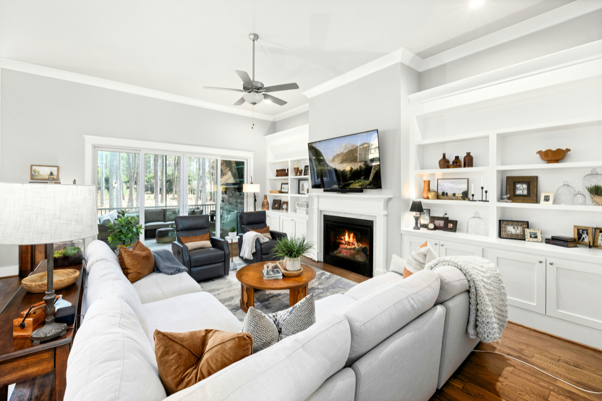 Bright, organized living room with built-in shelving and furniture arranged to support everyday use and easy movement.