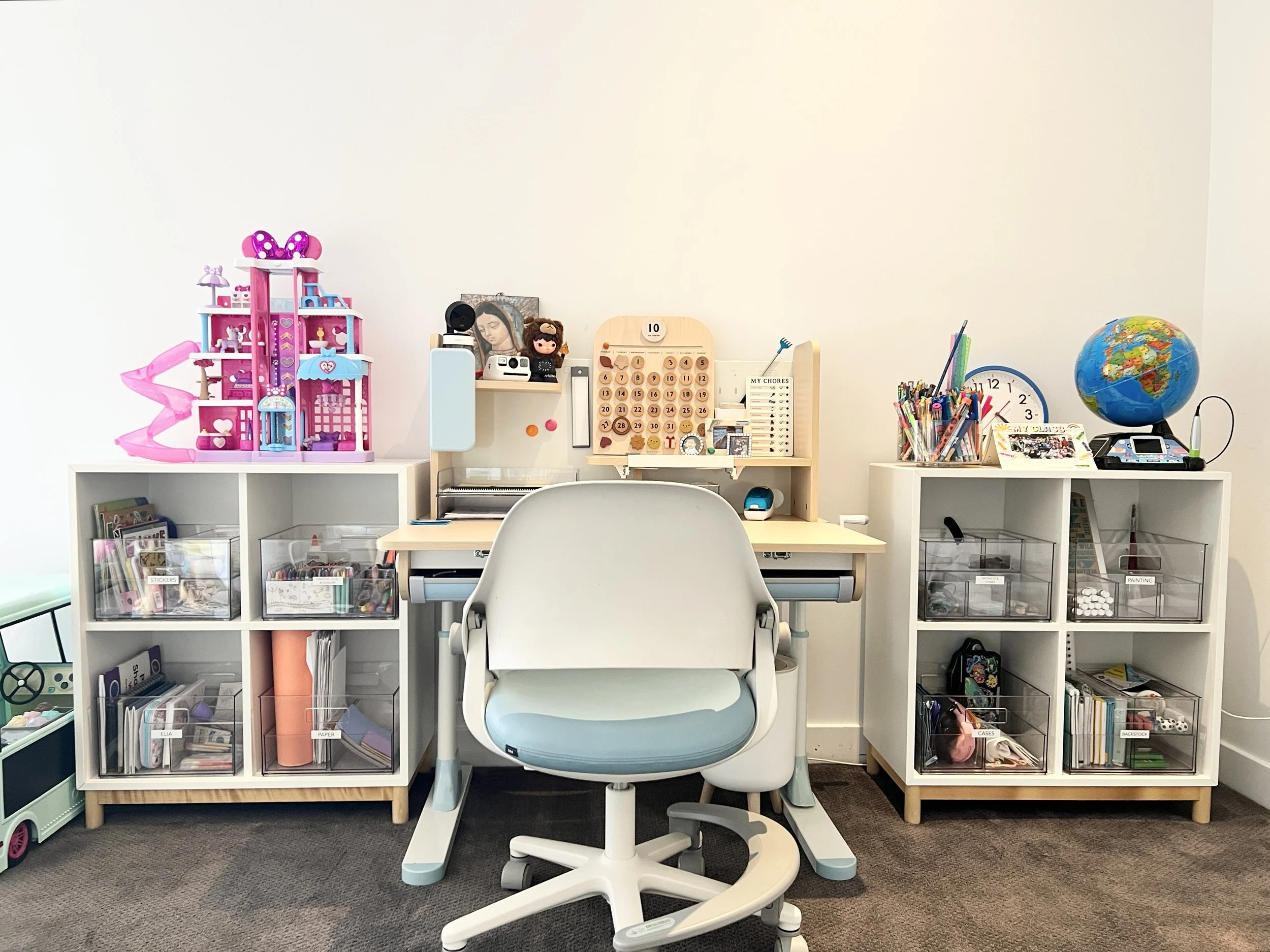 Custom children’s homework and creative station in Palos Verdes Estates, California, designed with clearly defined zones for schoolwork, art supplies, and daily routines. Open shelving and labeled storage support independence, focus, and easy resets,