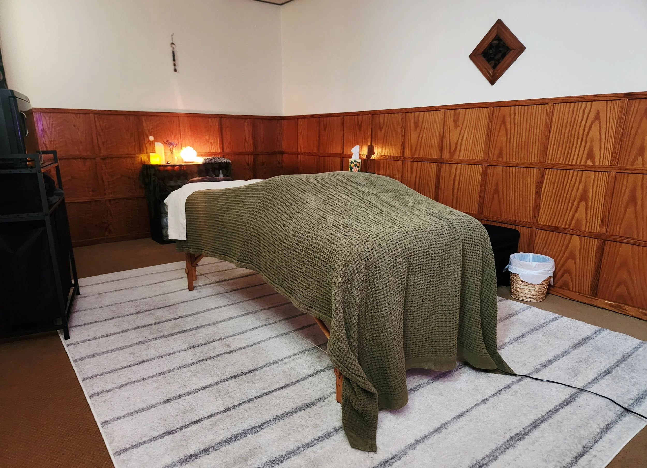 Calming massage room with a cozy comfortable bed in downtown Helena MT