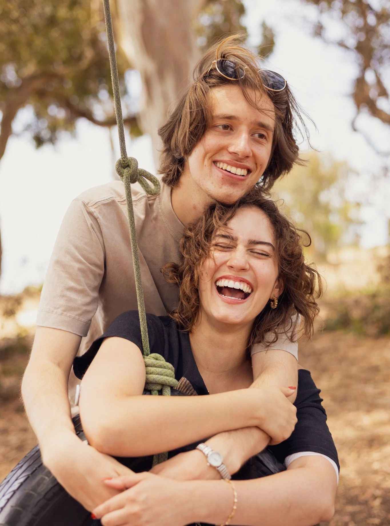 Two cuties and a tire swing.