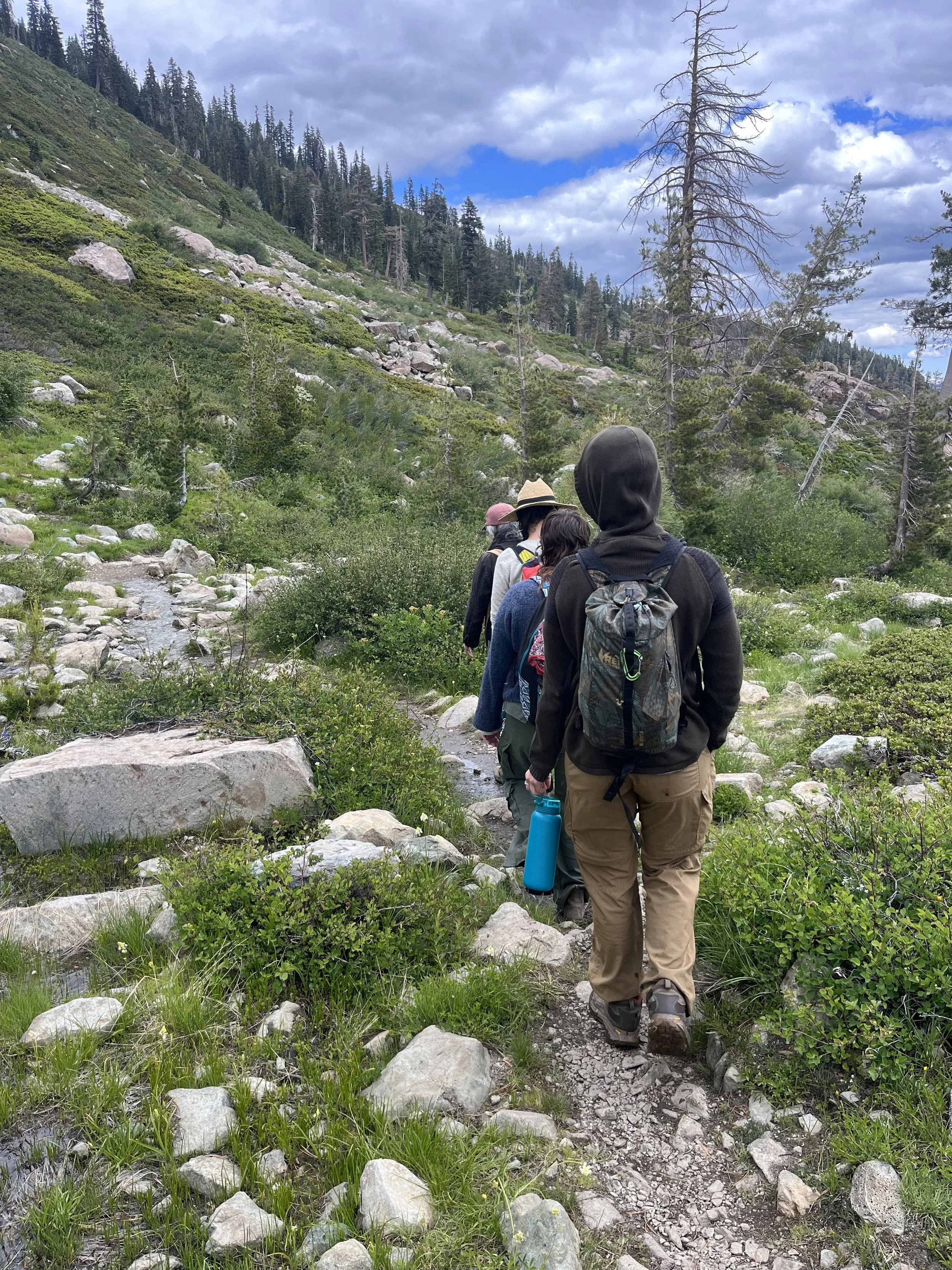 group of students on a hiking trail in the mountains