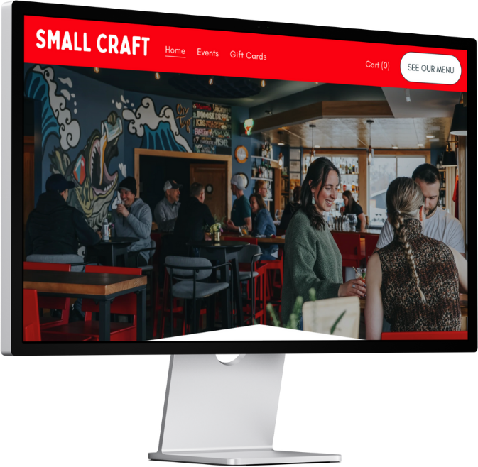 People enjoying drinks and conversation inside a casual restaurant or cafe with colorful mural art on the walls and large windows letting in natural light.