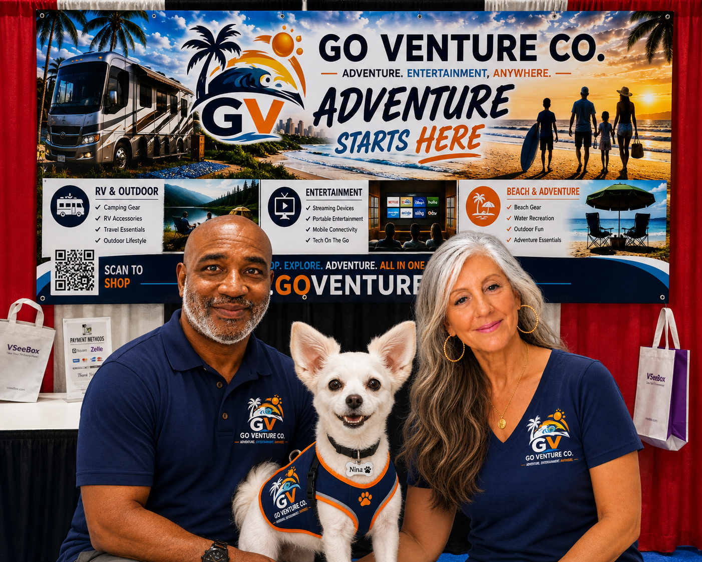 Two people and a dog at a travel expo booth for Go Venture Co., with a large banner behind them showcasing outdoor adventure options like RV camping, beach trips, and outdoor entertainment. The man has a gray beard and is wearing a navy polo shirt with the company logo, and the woman has long gray hair, hoop earrings, and is also wearing a navy shirt. The dog, named Nina, is wearing a harness with the company logo and is smiling.