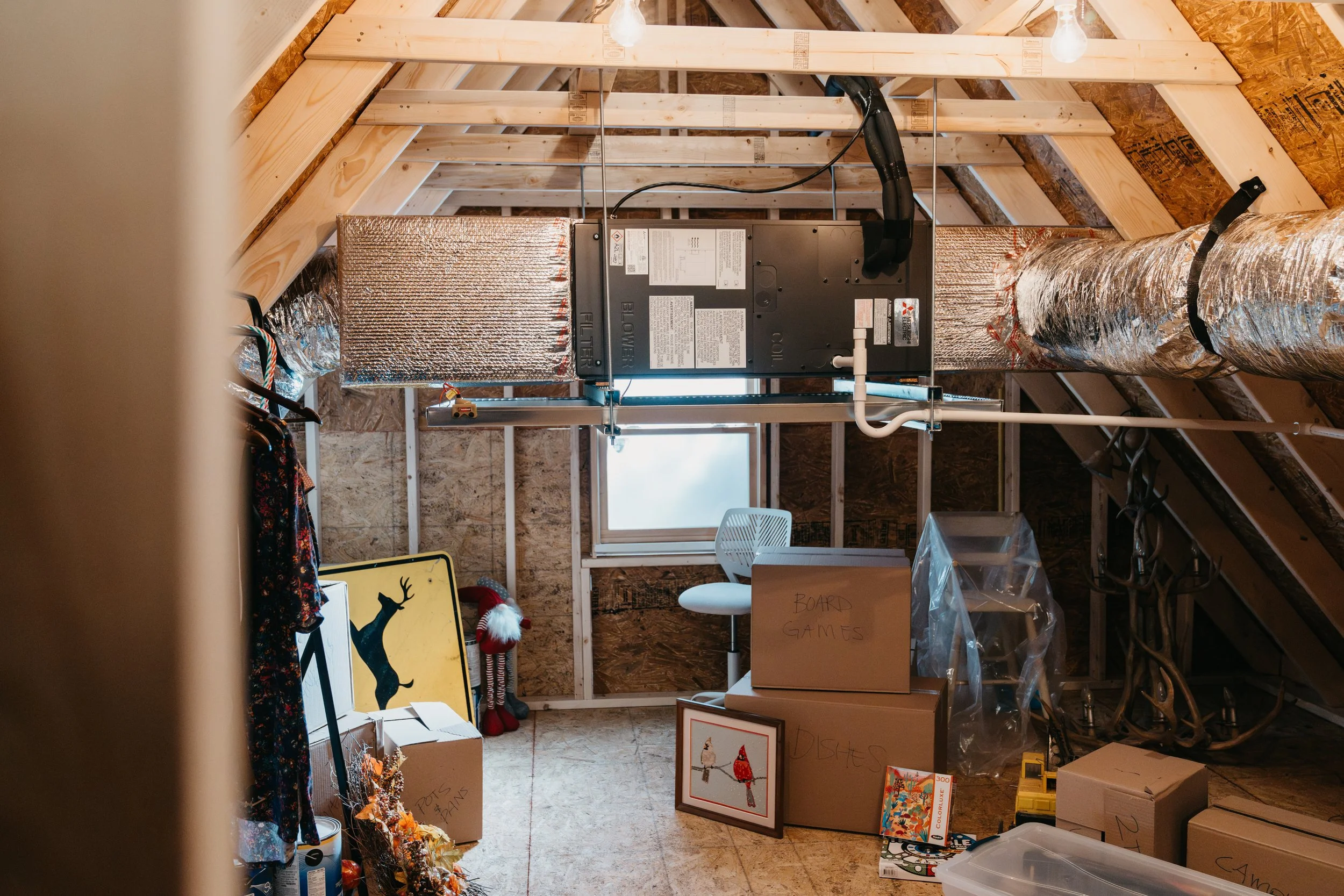 Ducted heat pump air handler installed in an attic with insulated ductwork in a Portland, Maine home.