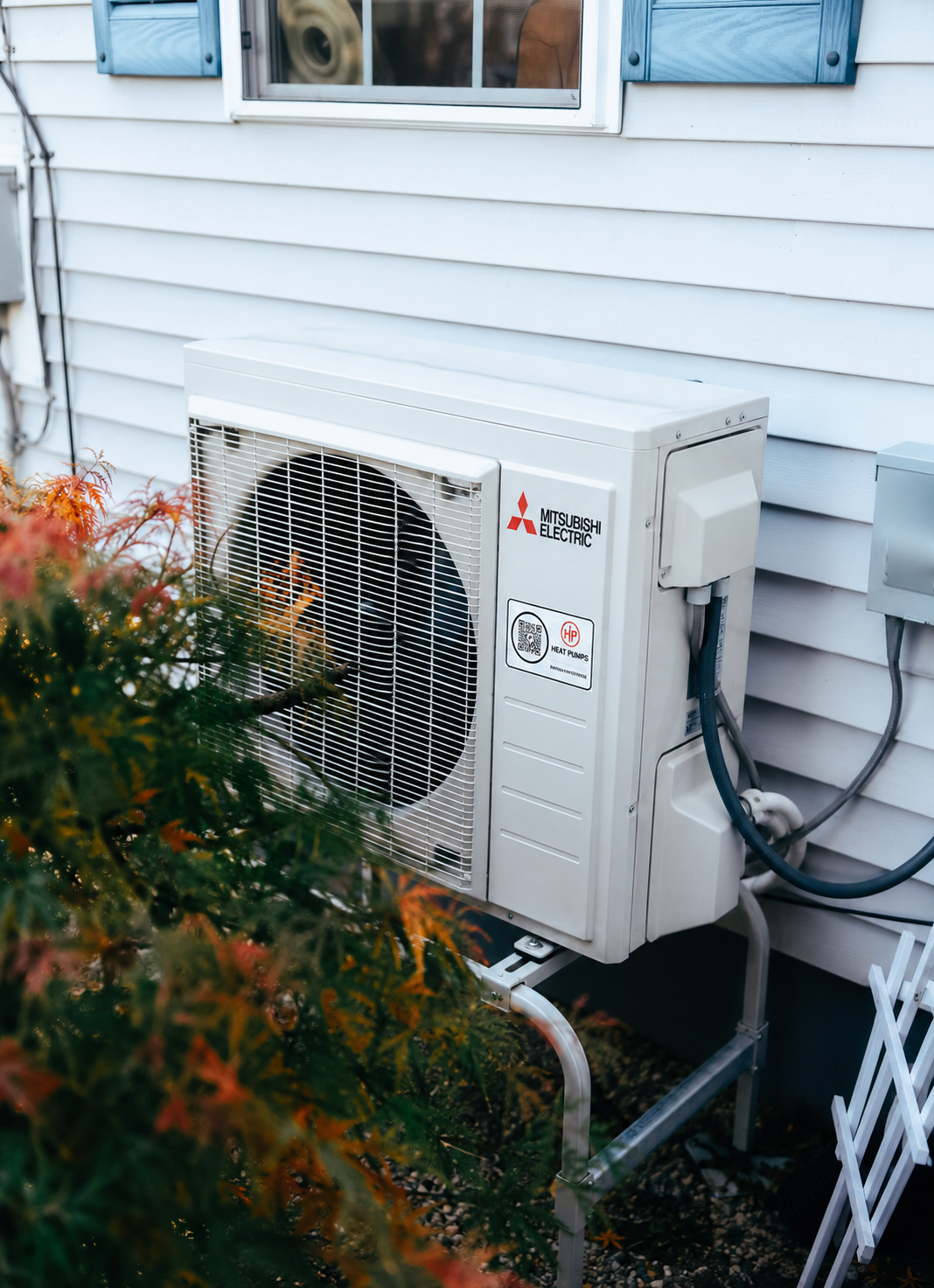 Mitsubishi Electric outdoor heat pump unit installed at a Maine home.