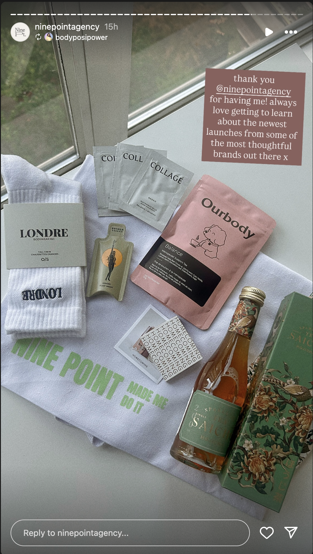 A collection of skincare, wellness, and lifestyle products arranged on a white cloth with green text that reads "NINE POINT MADE ME DO IT." Items include face masks, a tube of body wash, a sock with the brand name "LONDRE," a packet of Ourbody herbal tea, a small bottle of sauce, a floral gift box, and a small bottle of hot sauce, near a window with natural light.