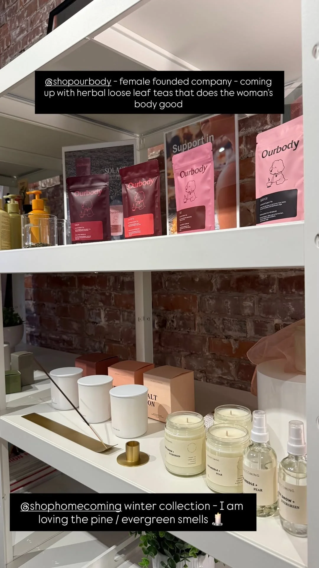 Display of skincare and wellness products including herbal loose leaf teas, candles, and skincare items on white shelves with brick wall background.
