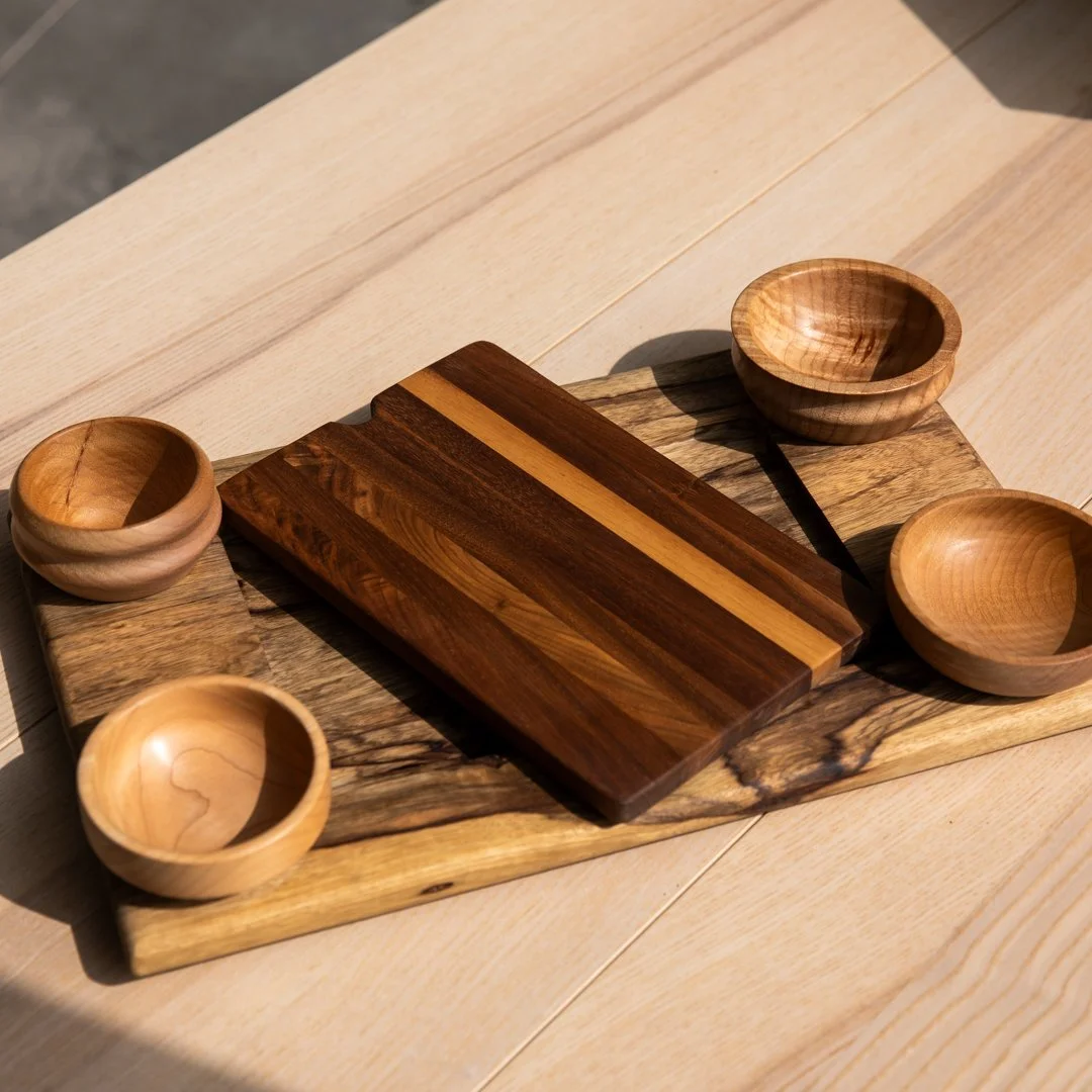 Elevate your hosting game with this handcrafted modular charcuterie board set. Designed for both beauty and utility, the piece features a stunning live-edge base, four removable hand-turned bowls, and a perfectly sized cutting board that nests seamle