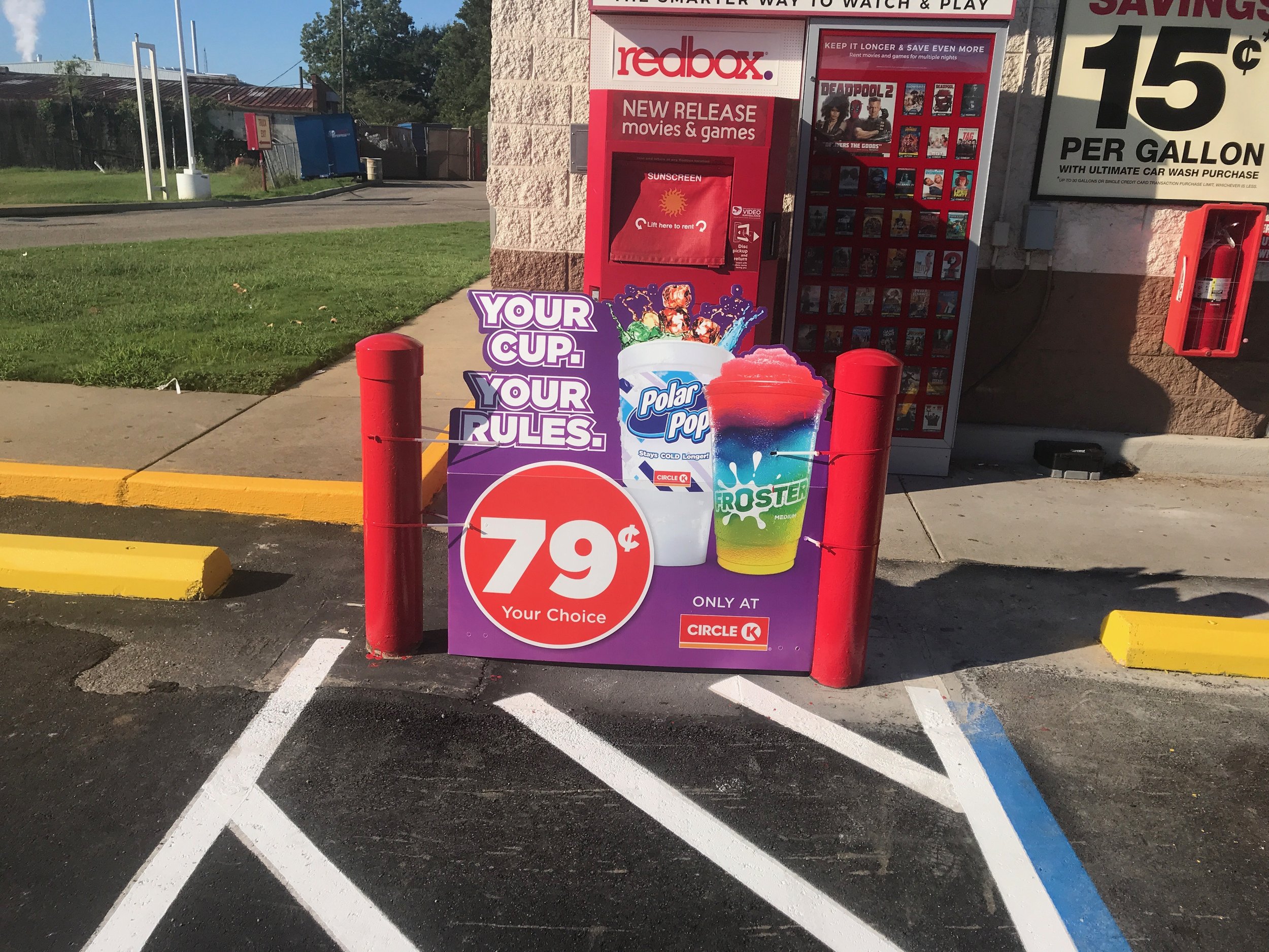 A vibrant red and purple sign reads "Your sales are 79 cents," set against a backdrop of white striped pavement.