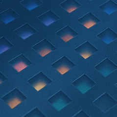 Close-up of a metallic surface with a grid of small, evenly spaced square holes, reflecting colorful lights from underneath.