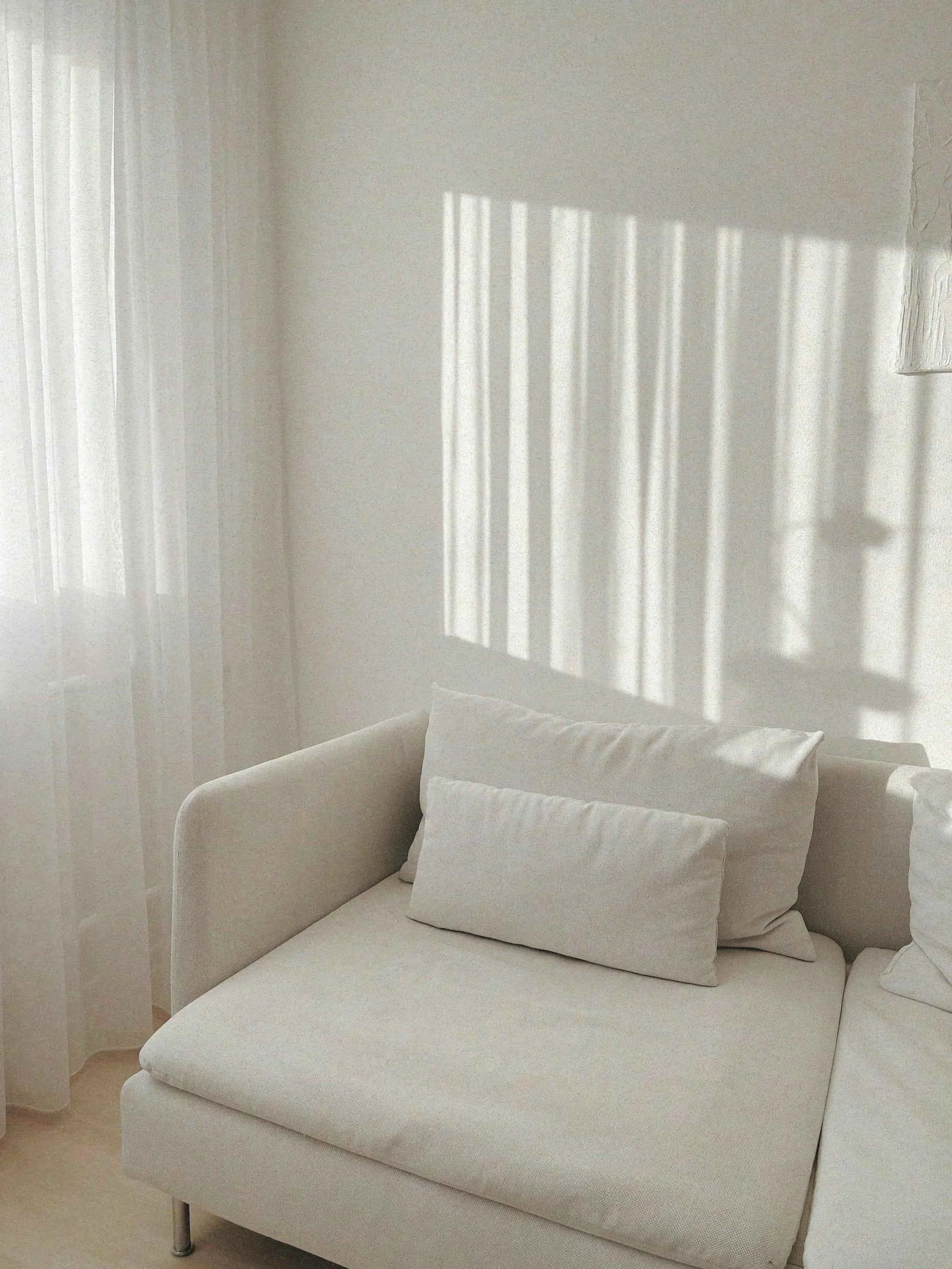 Bright and calming therapy room with natural light and a soft cream sofa at Return to Self
