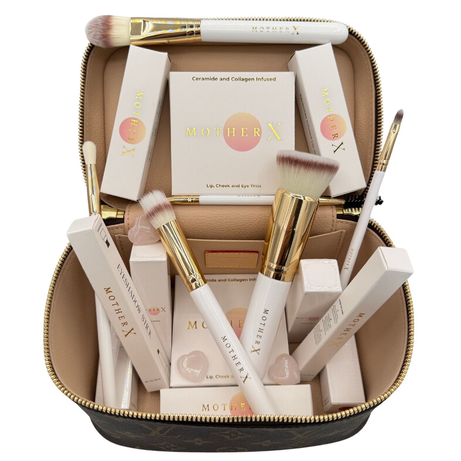 Open makeup case containing Mother X beauty products including lip, cheek, and eye tints, along with brushes and eye masks.