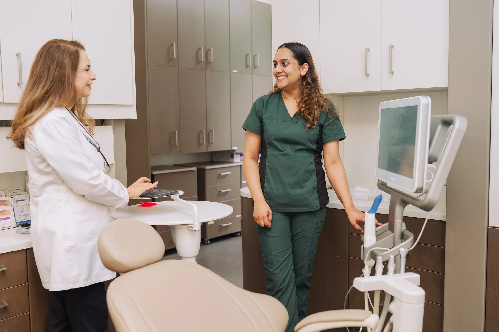Dr. Efat Farrokshad and team member preparing a treatment room at Aarm Dental Group on Beatty, delivering compassionate, advanced dental care. We combine skilled treatment and communication to support healthy smiles for life.