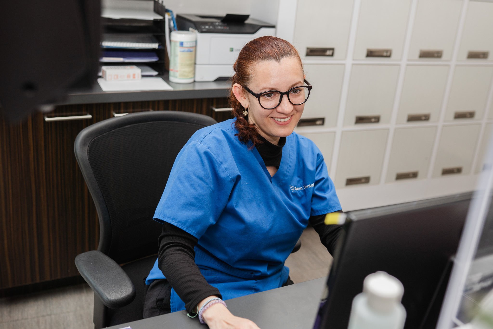 Welcoming front desk team at Aarm Dental at BC Place, helping patients navigate insurance and the Canadian Dental Care Plan (CDCP) with direct billing and transparency. Affordable, patient-first dental care starts here.