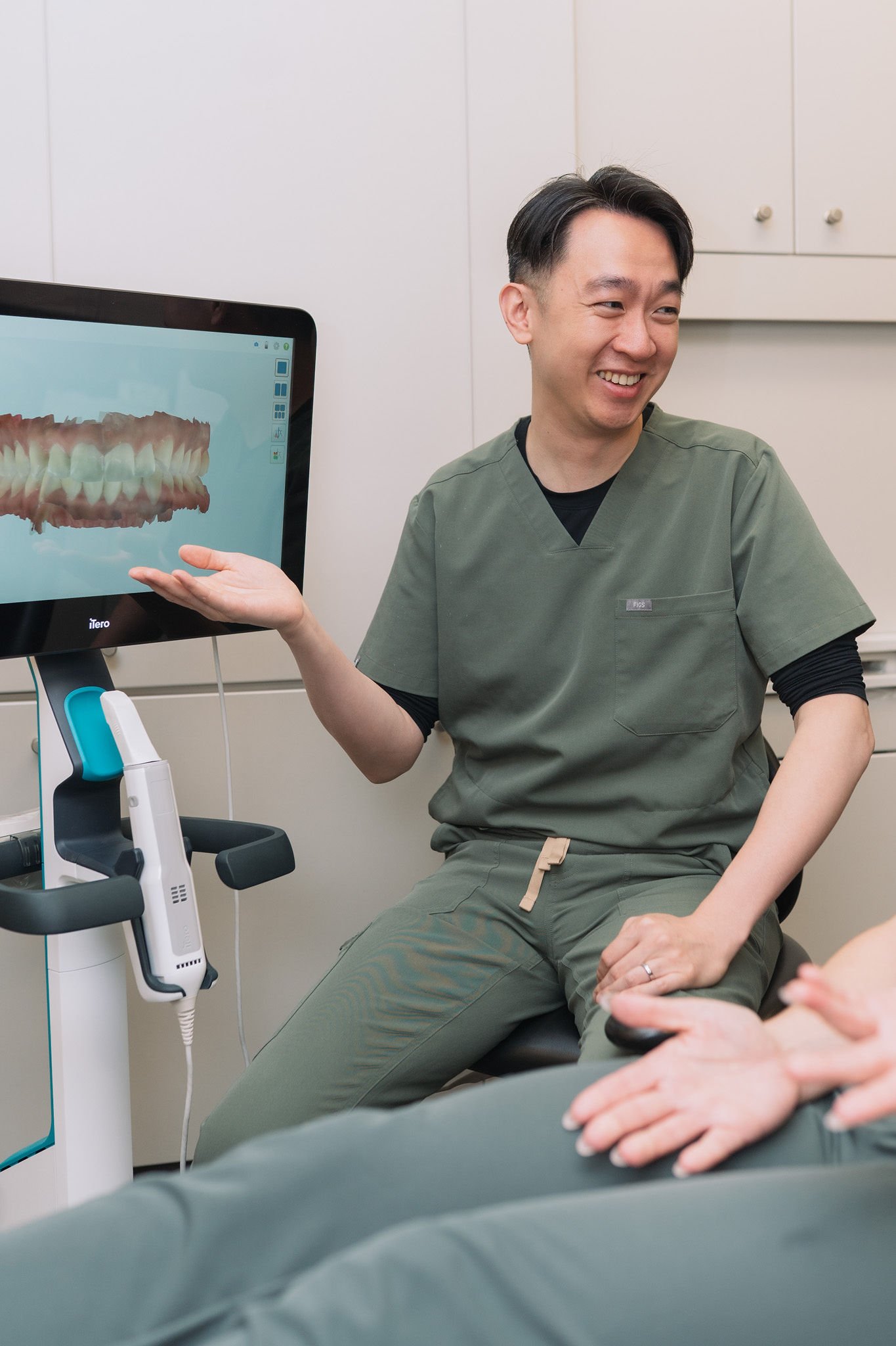 Dr. Anderson Hsu speaking with a patient during their cosmetic consultation at Aarm Dental Group on Denman. We listen, support, & help you make confident choices about your oral health.