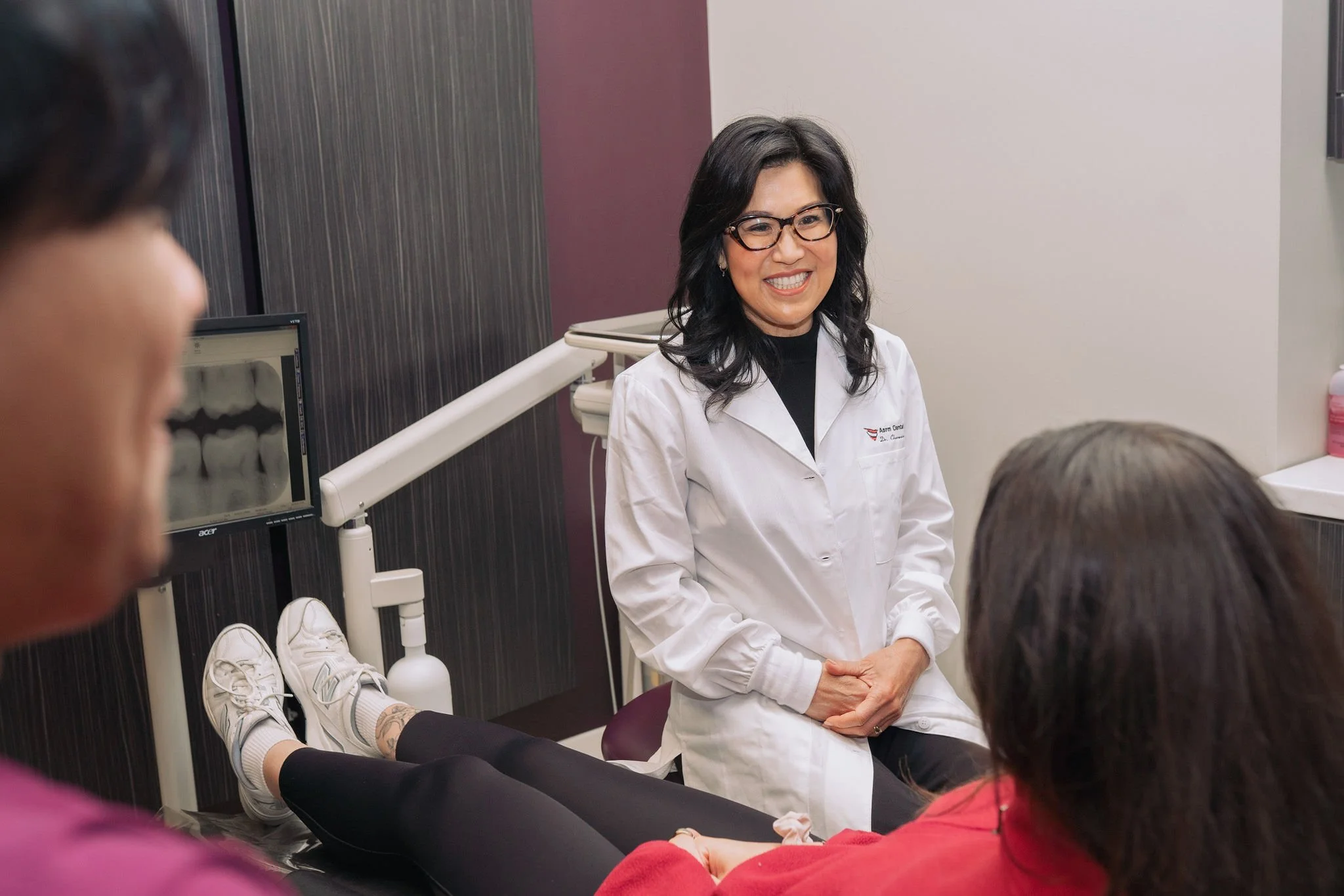 Dr. Charmaine Fong speaking with a patient during their cosmetic consultation at Aarm Dental Group on Hornby. We listen, support, & help you make confident choices about your oral health.