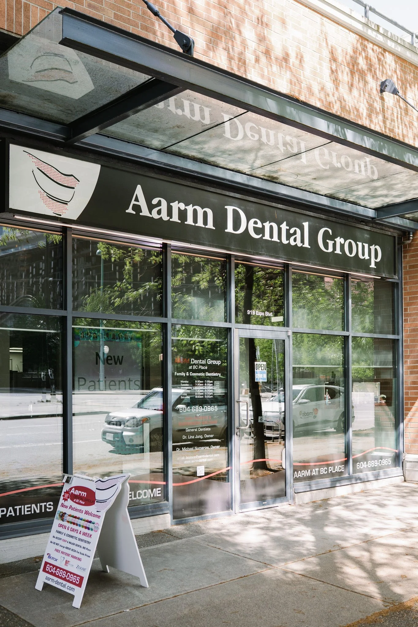 Aarm Dental Group clinic exterior at BC Place, accepting new patients for affordable cosmetic and emergency dental care. We provide family & cosmetic dentistry without charging above the BCDA fee guide.